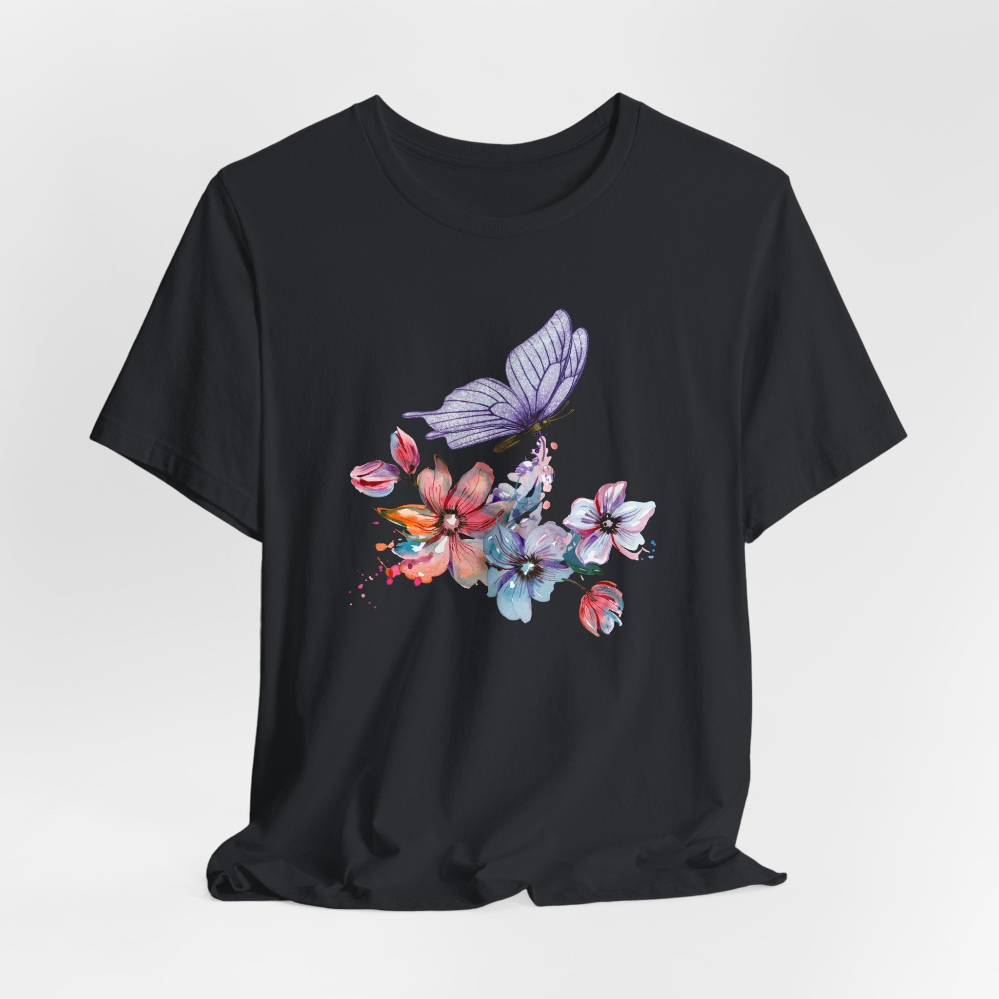 Black t-shirt with a colorful butterfly and floral design on a white background