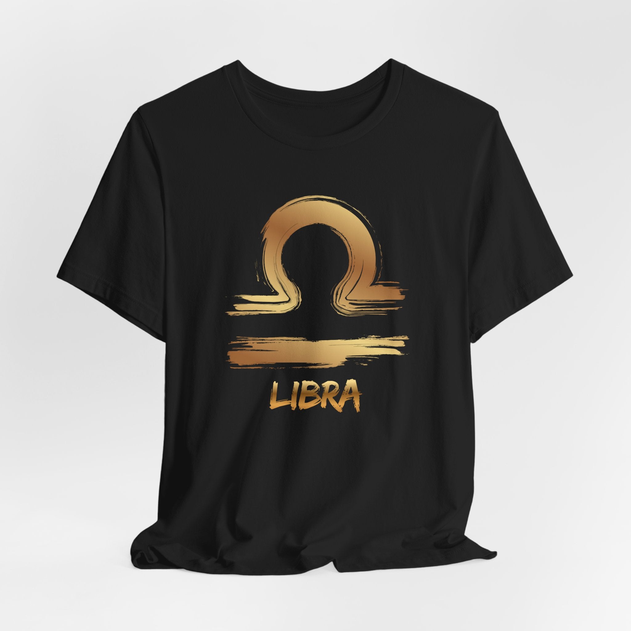 Black t-shirt with gold Libra zodiac symbol on a white background