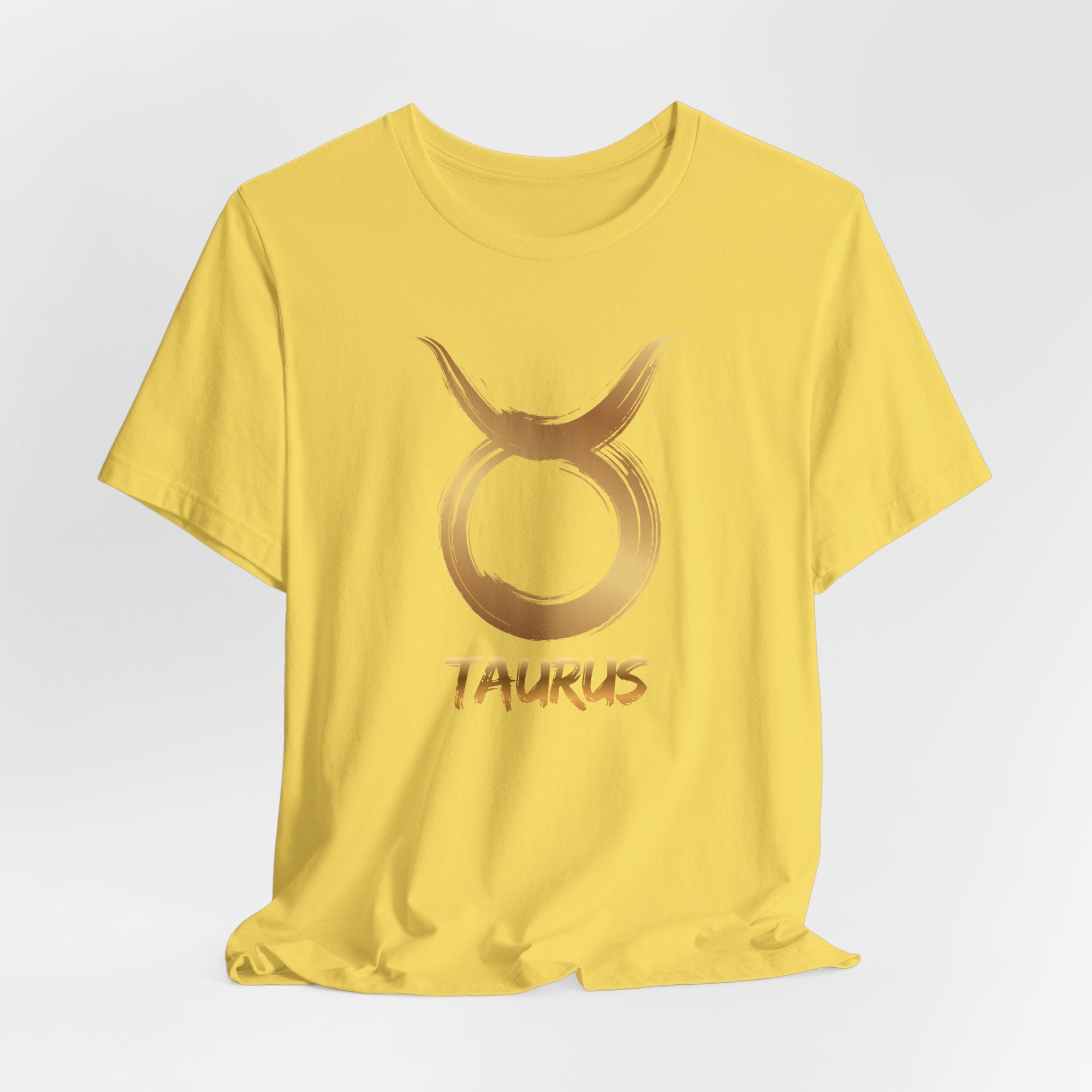 Yellow t-shirt with Taurus zodiac sign graphic on a light gray background