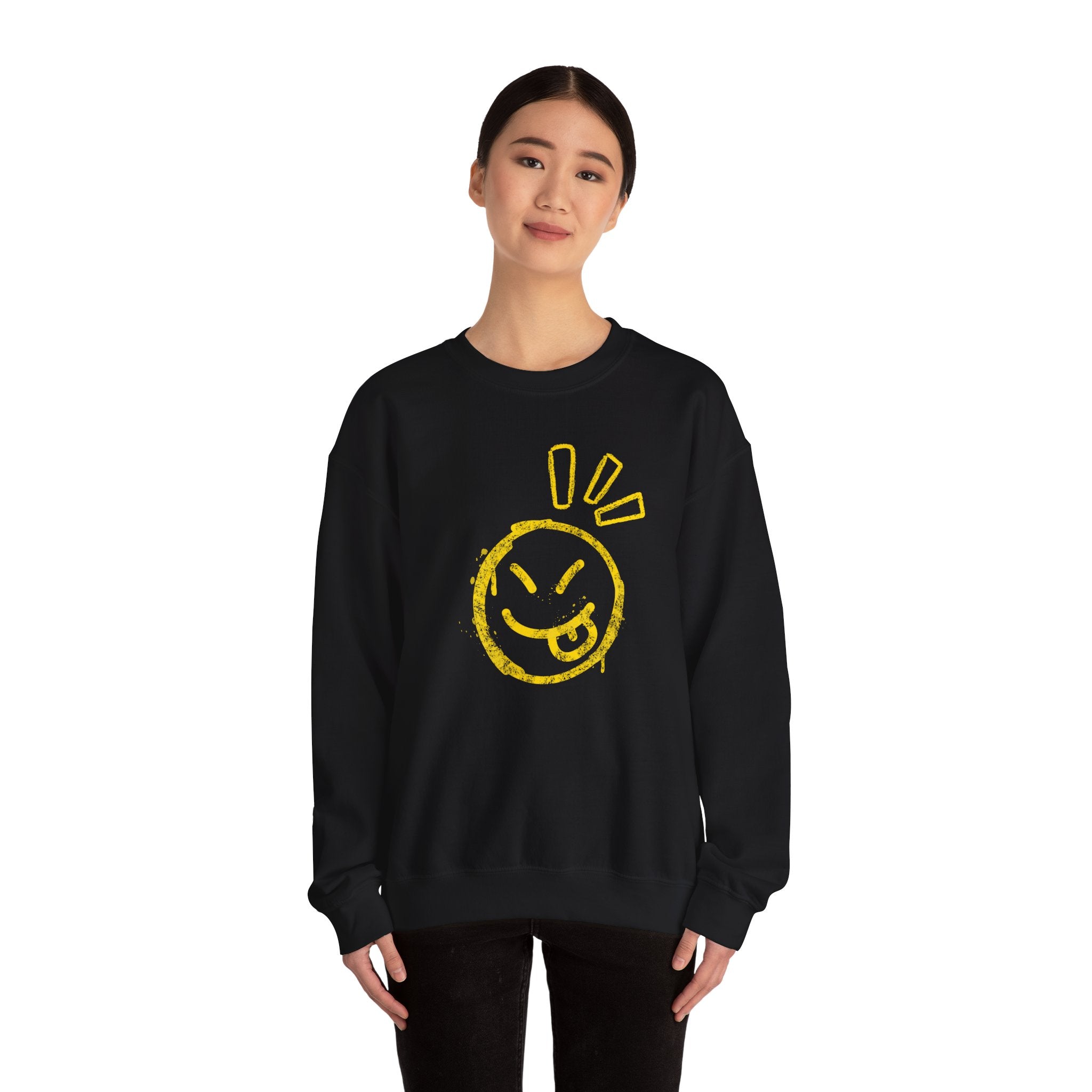 Person wearing a black sweatshirt with a yellow smiley face design on a white background