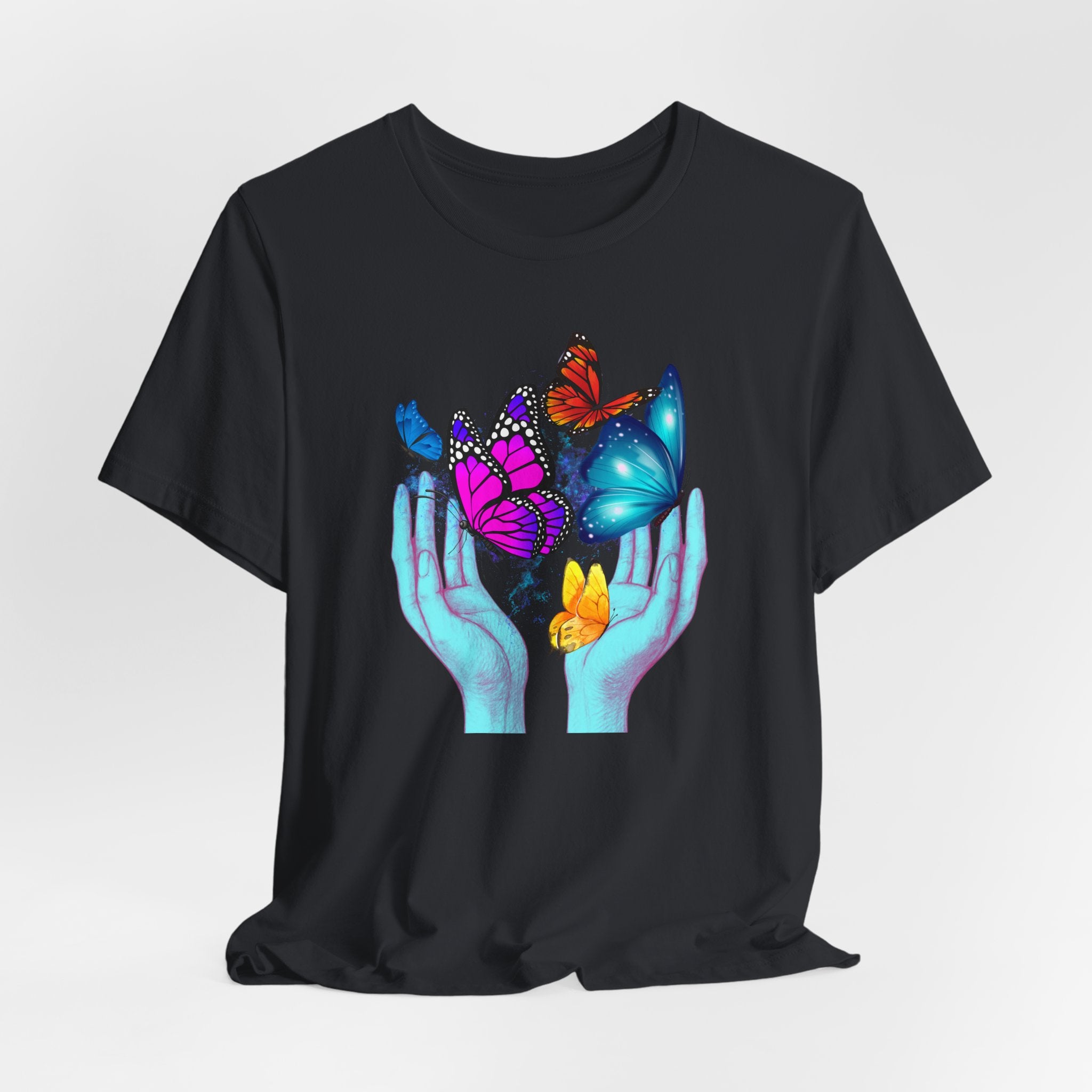 Black t-shirt with colorful butterfly design on a plain background