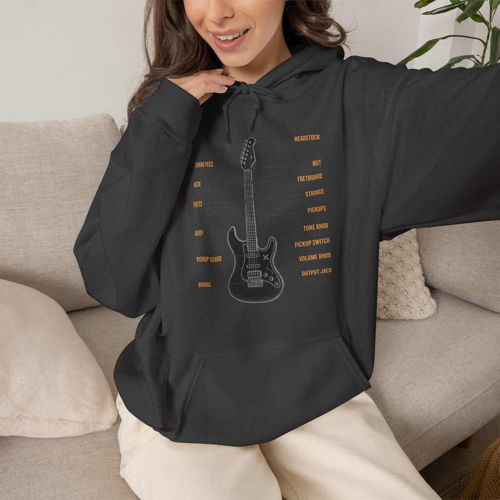 Person wearing a black hoodie with a guitar graphic and text, sitting on a couch.