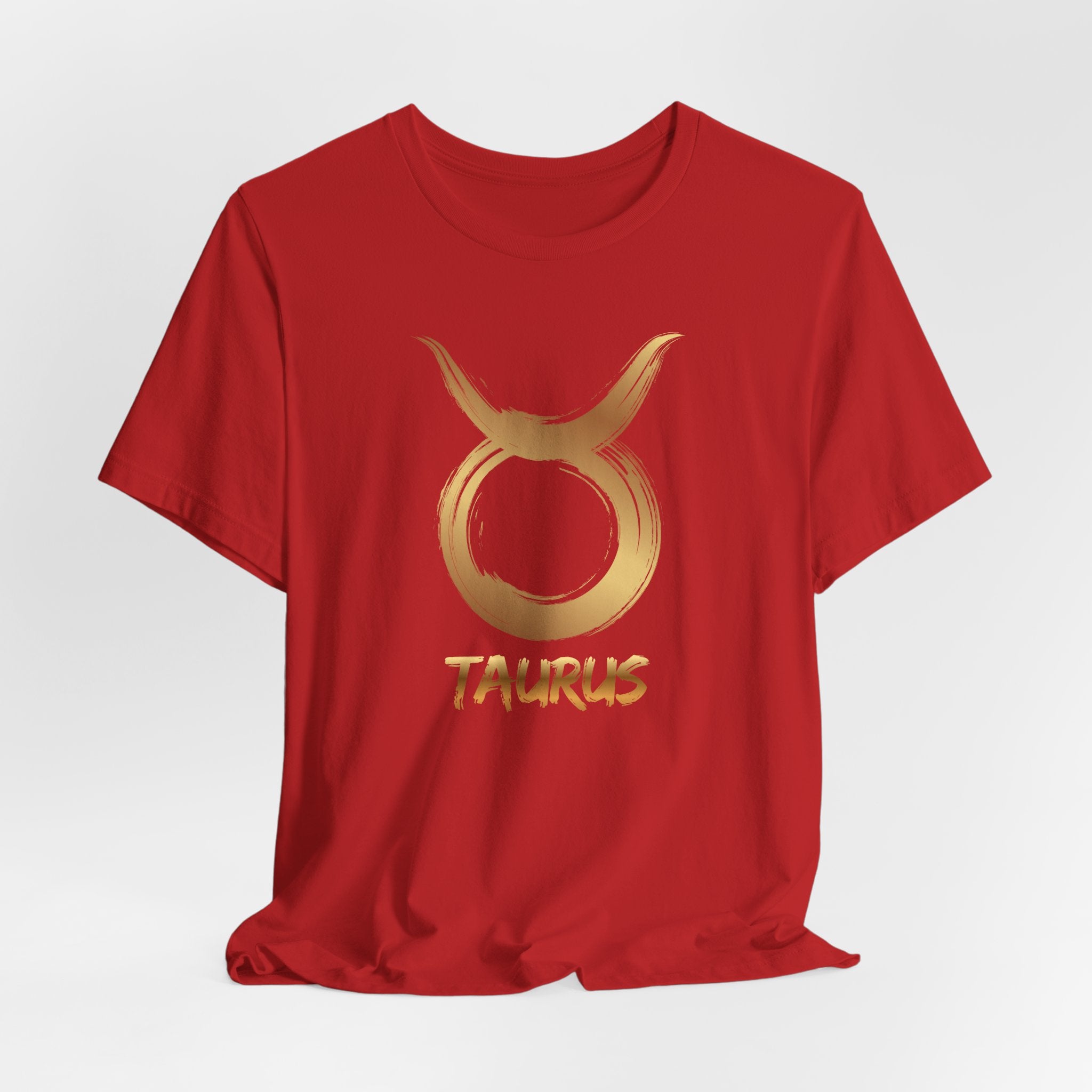 Red t-shirt with gold Taurus symbol and text on a white background
