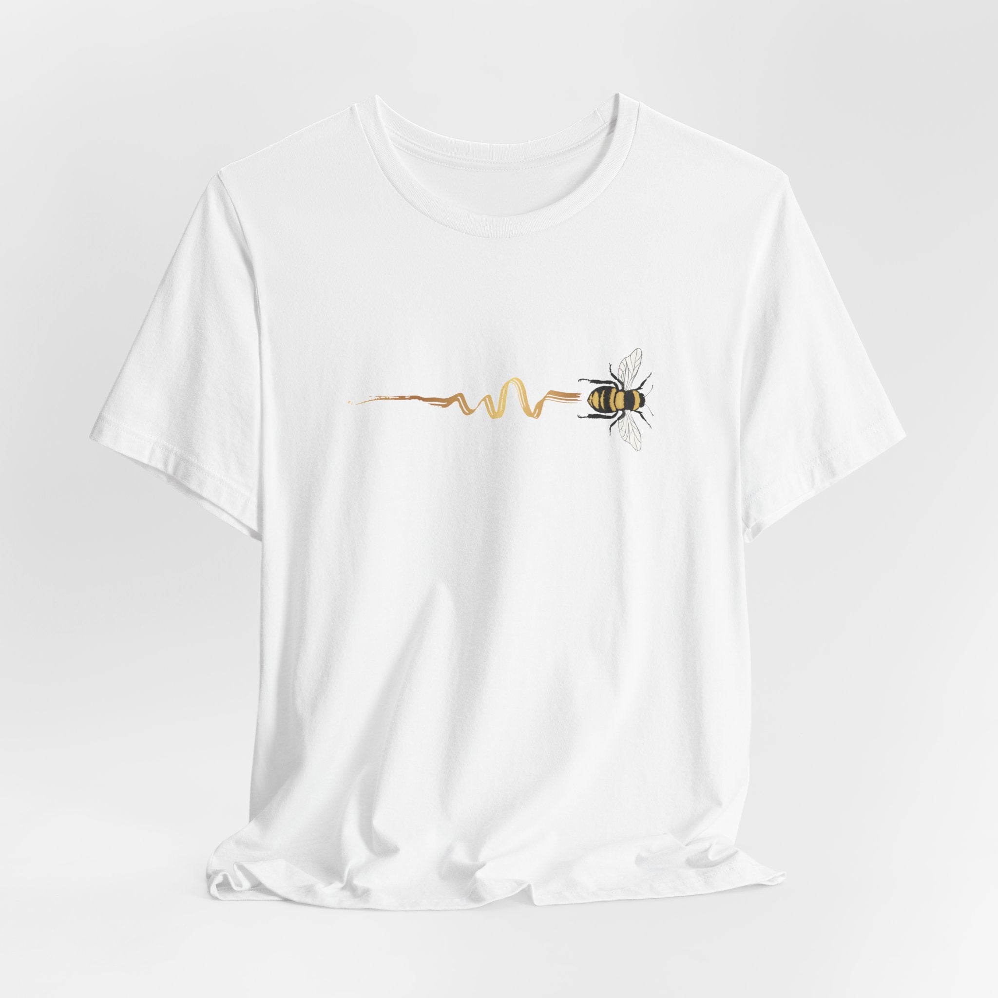 White t-shirt with a bee and pulse line design on a light gray background