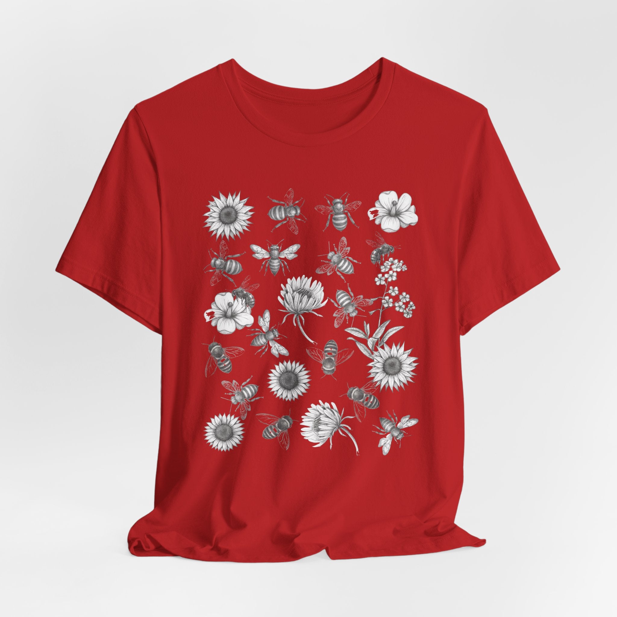 Red t-shirt with floral and bee design on a white background