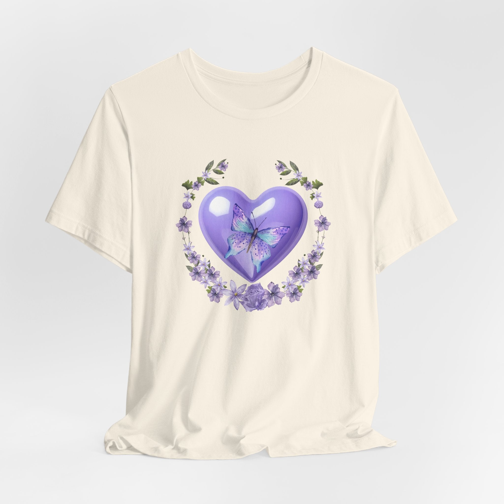 White t-shirt with a purple heart and butterfly design on a light gray background