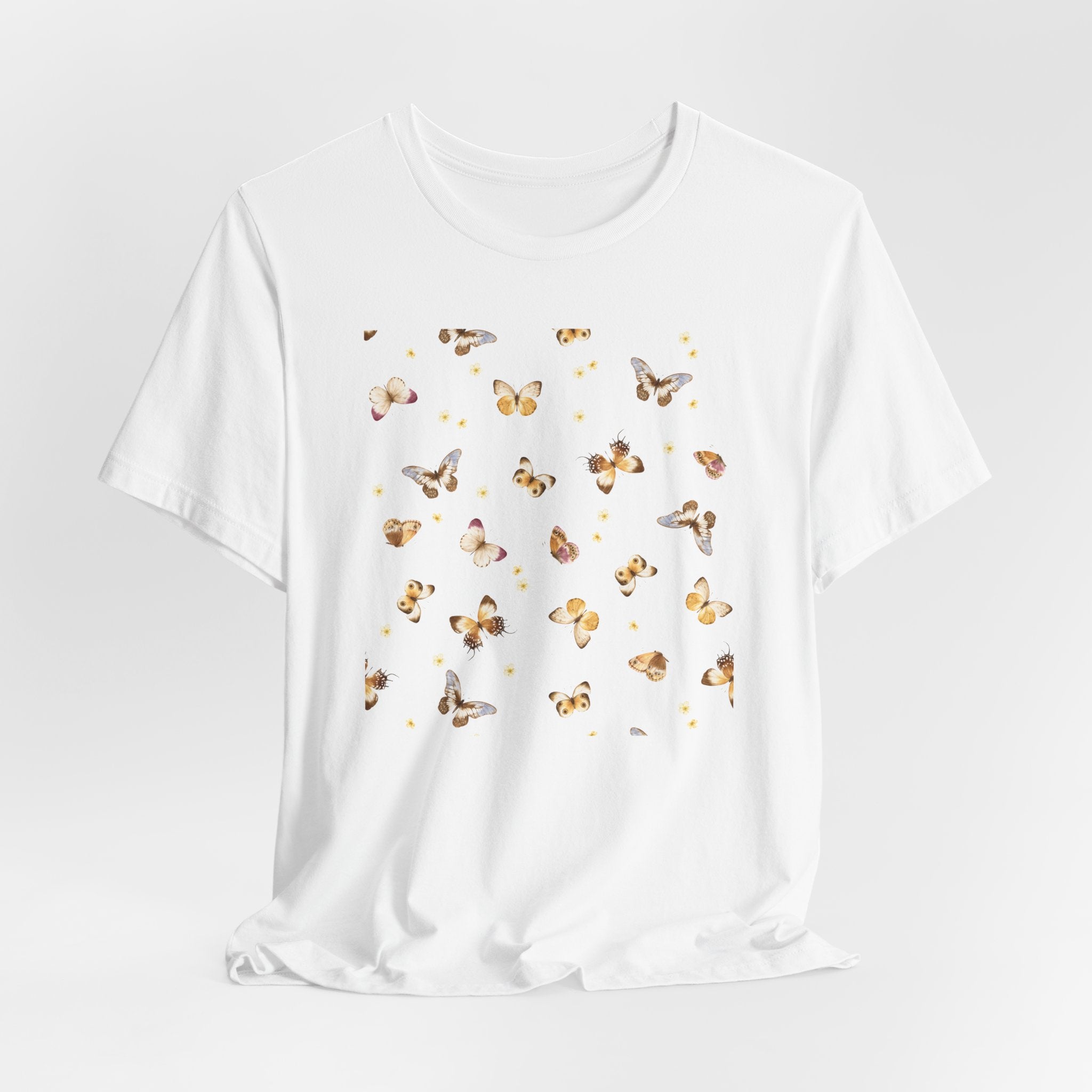 White t-shirt with butterfly pattern on a light gray background