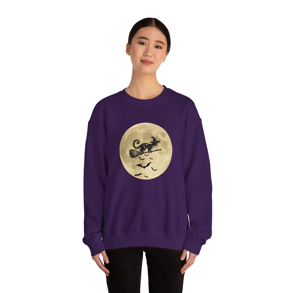 Person wearing a purple sweatshirt with a Halloween design of a cat on a moon and bats on a white background