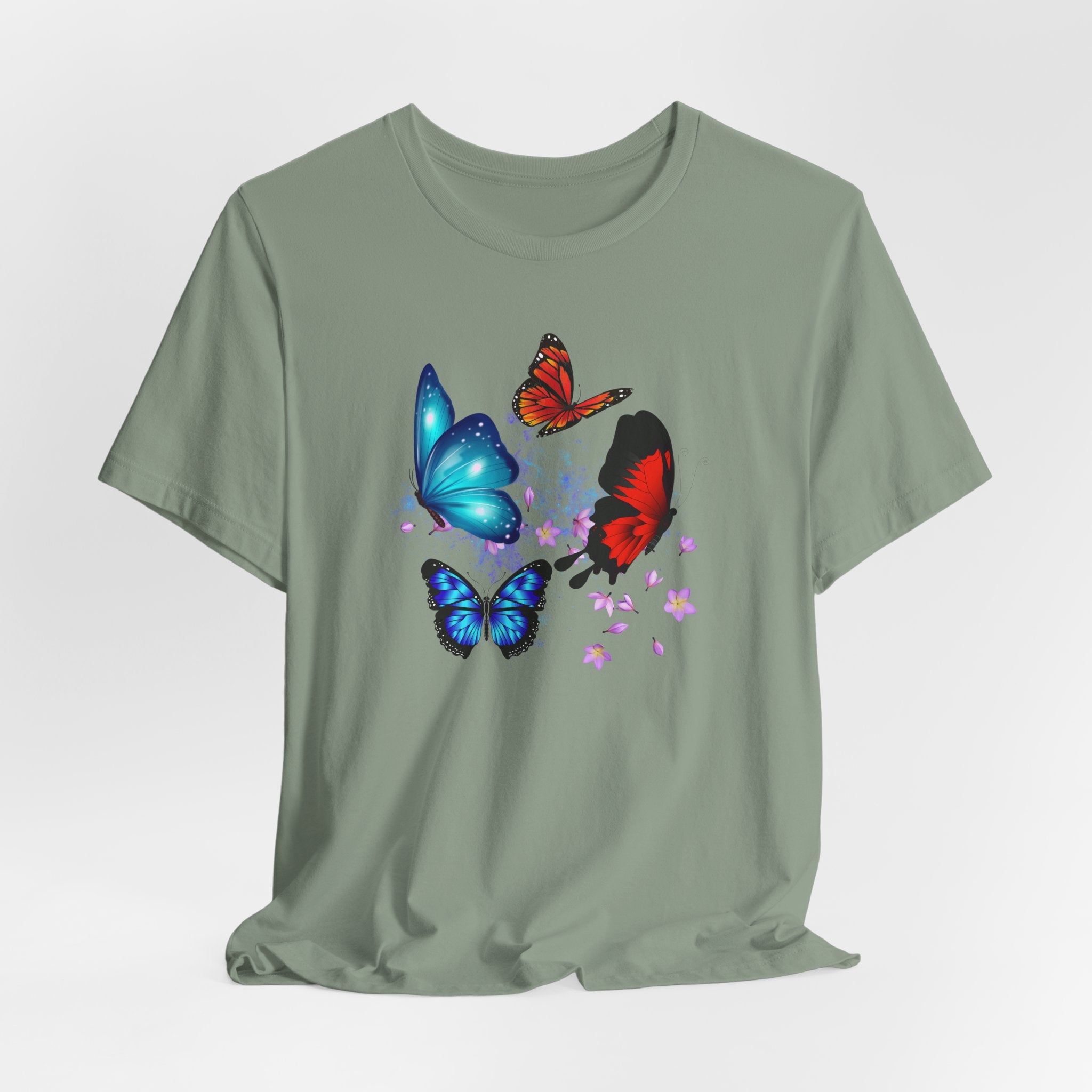Green t-shirt with colorful butterfly designs on a light gray background