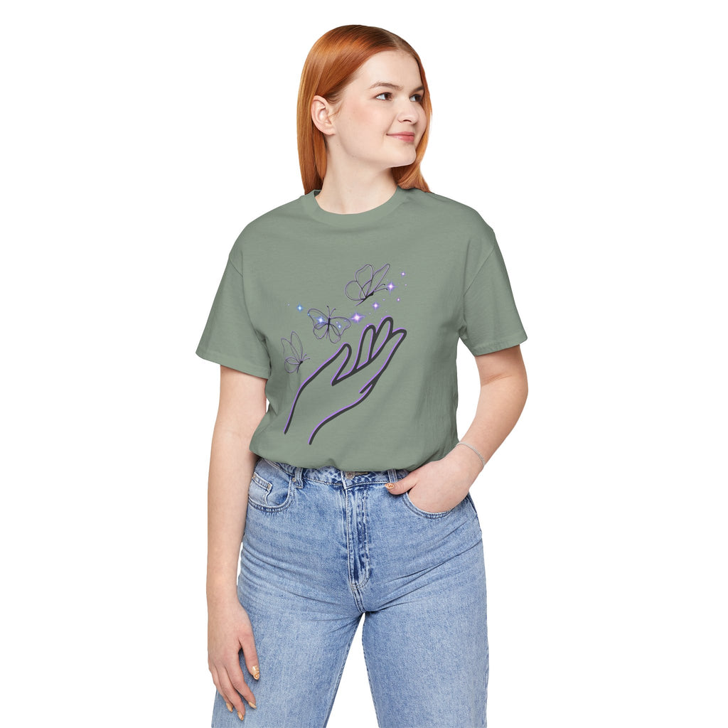 Person wearing a green t-shirt with a graphic design on a white background