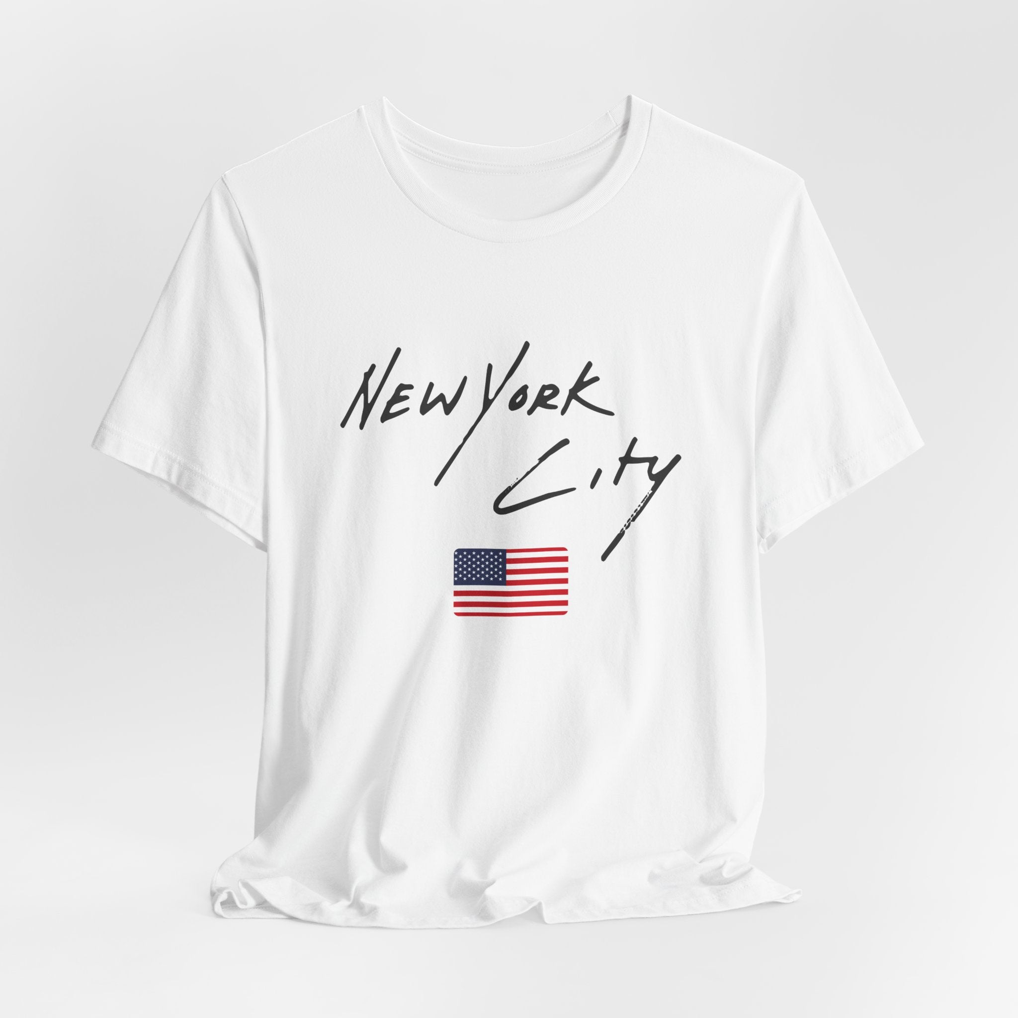 White t-shirt with 'New York City' text and American flag on a light gray background