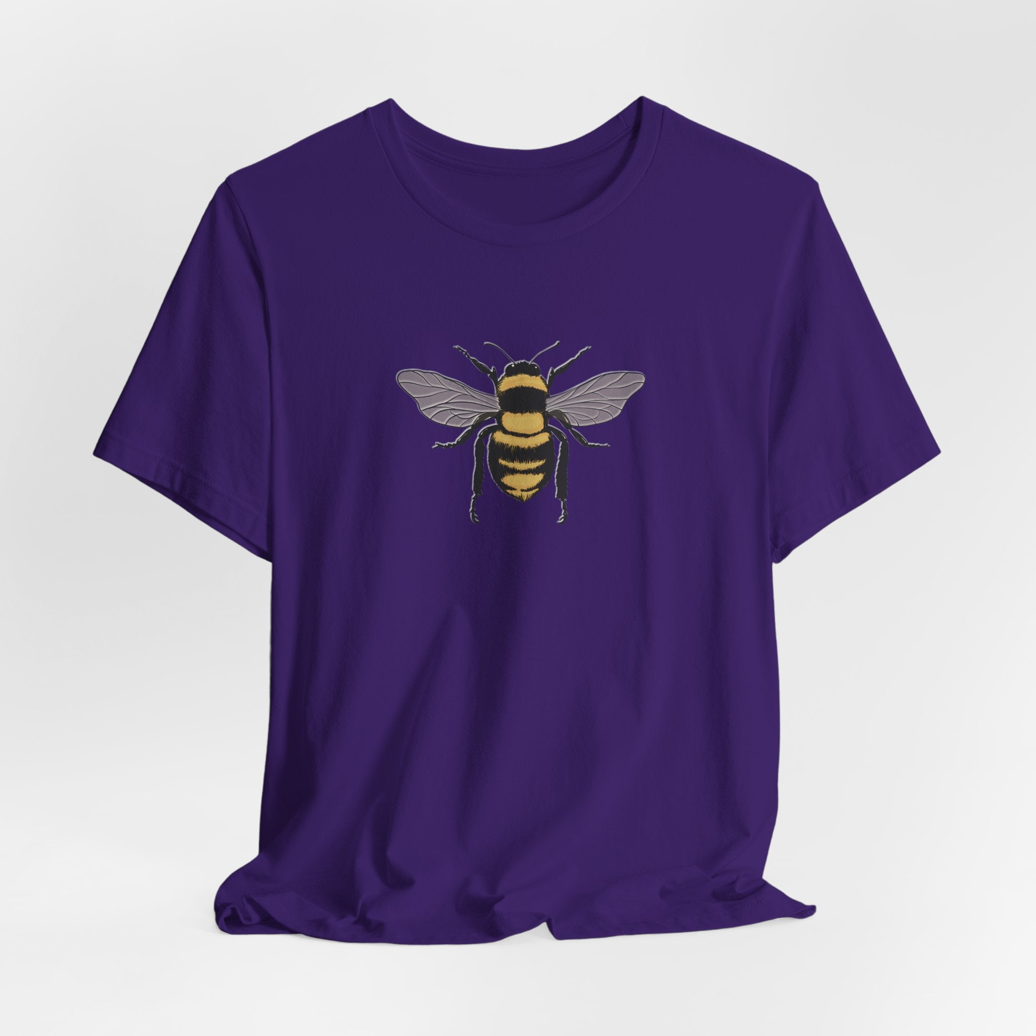 Purple t-shirt with a bee design on a light gray background