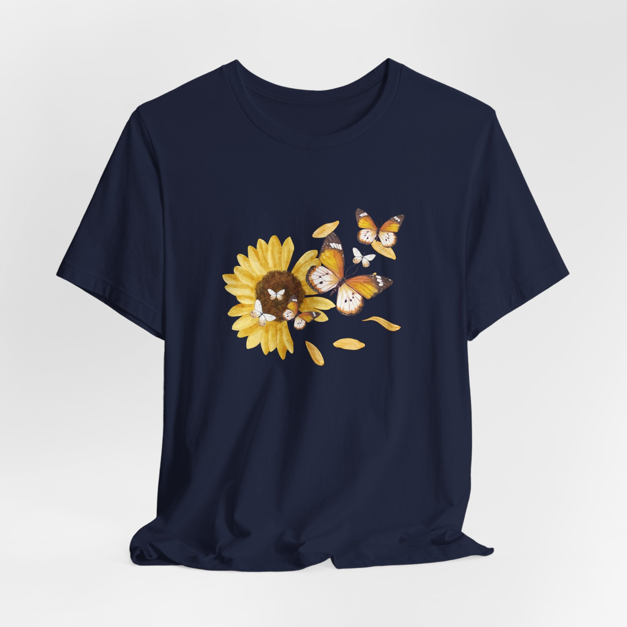 Navy blue t-shirt with a sunflower and butterfly design on a light gray background