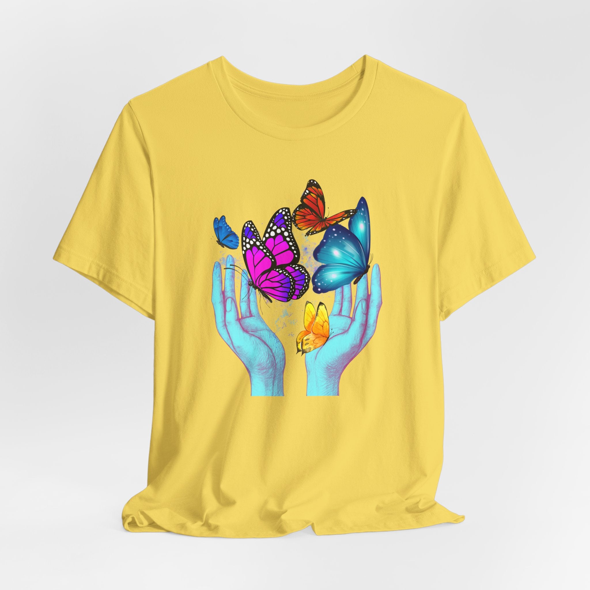 Yellow t-shirt with colorful butterfly design on a white background