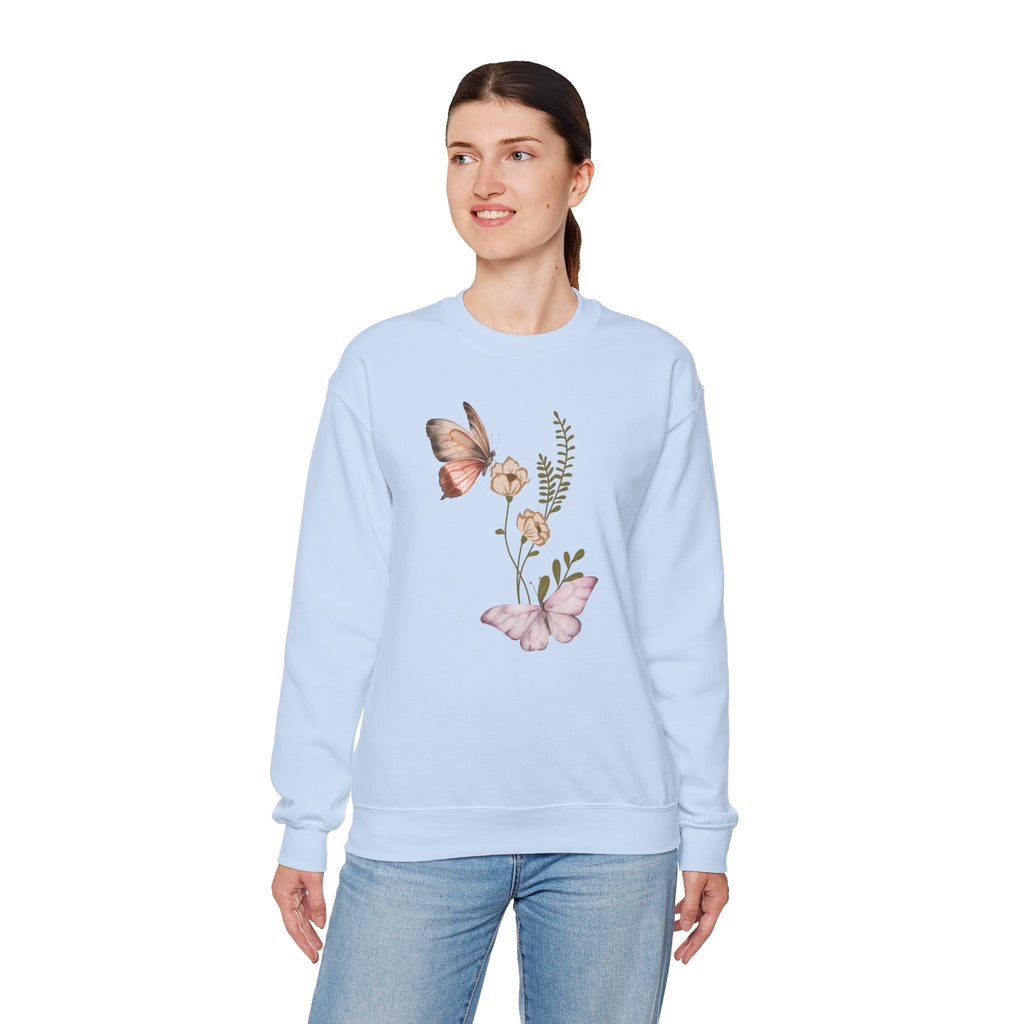 Woman wearing a light blue sweatshirt with butterfly and floral design on a white background