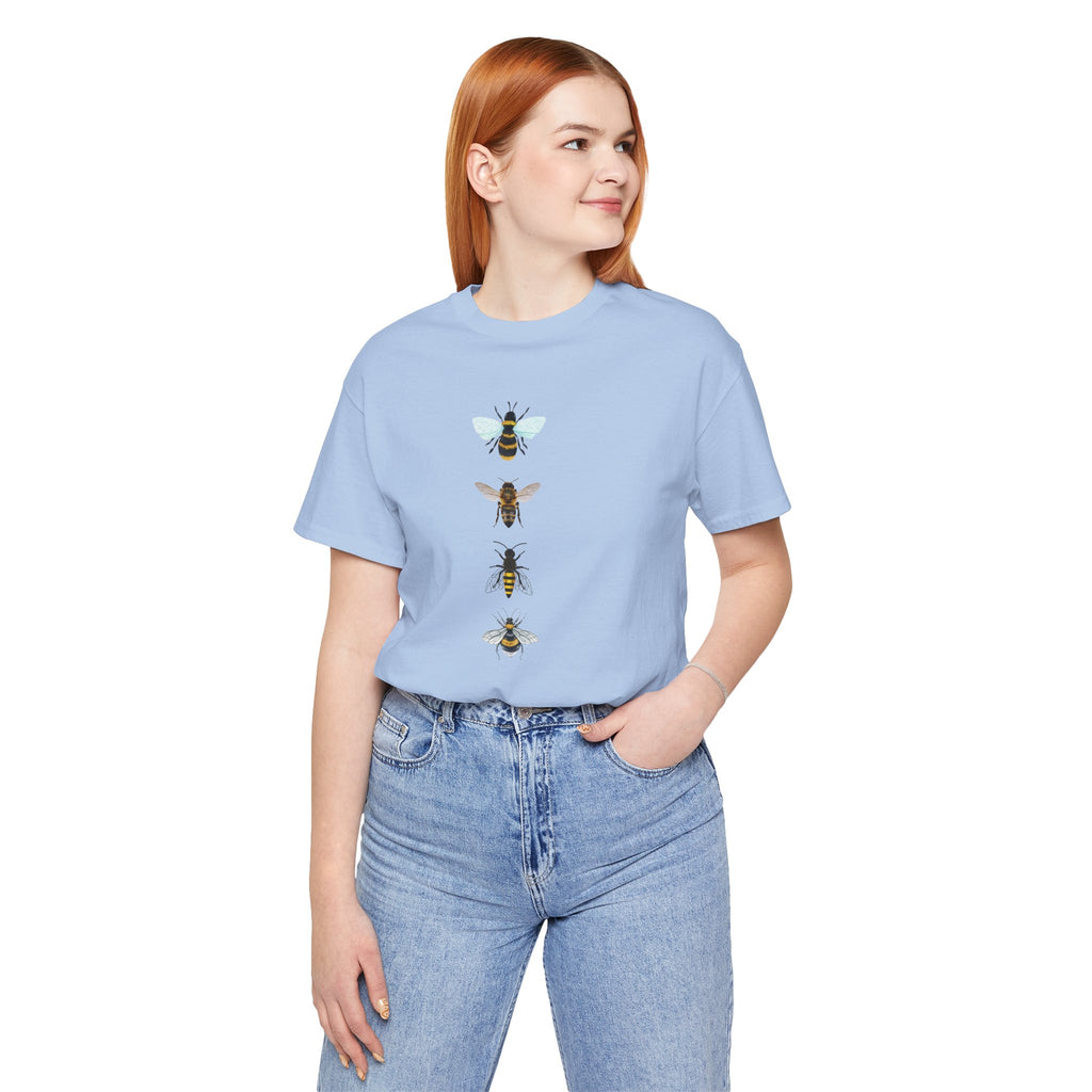 Person wearing a light blue t-shirt with bee designs on a white background
