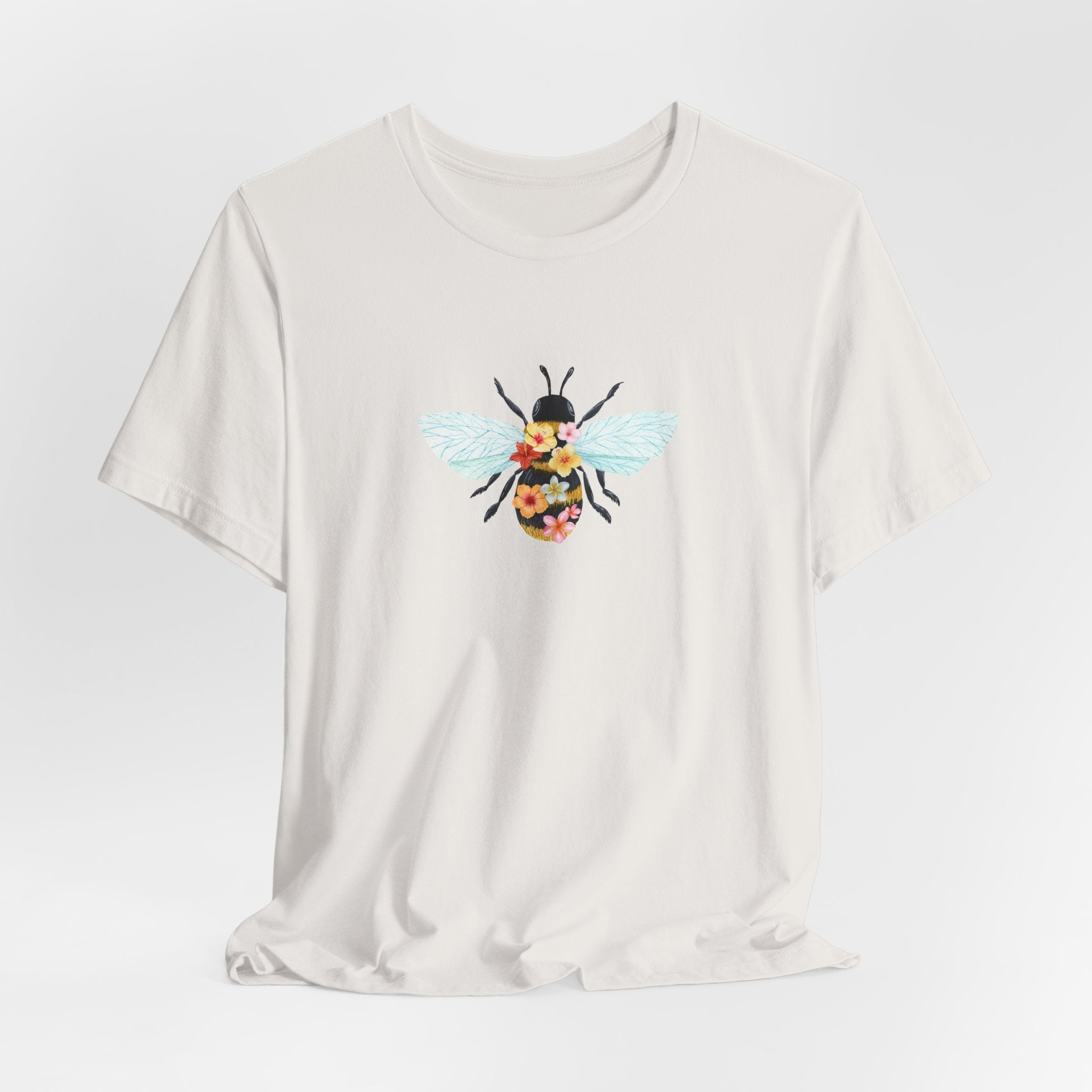 White t-shirt with a bee graphic on a light gray background