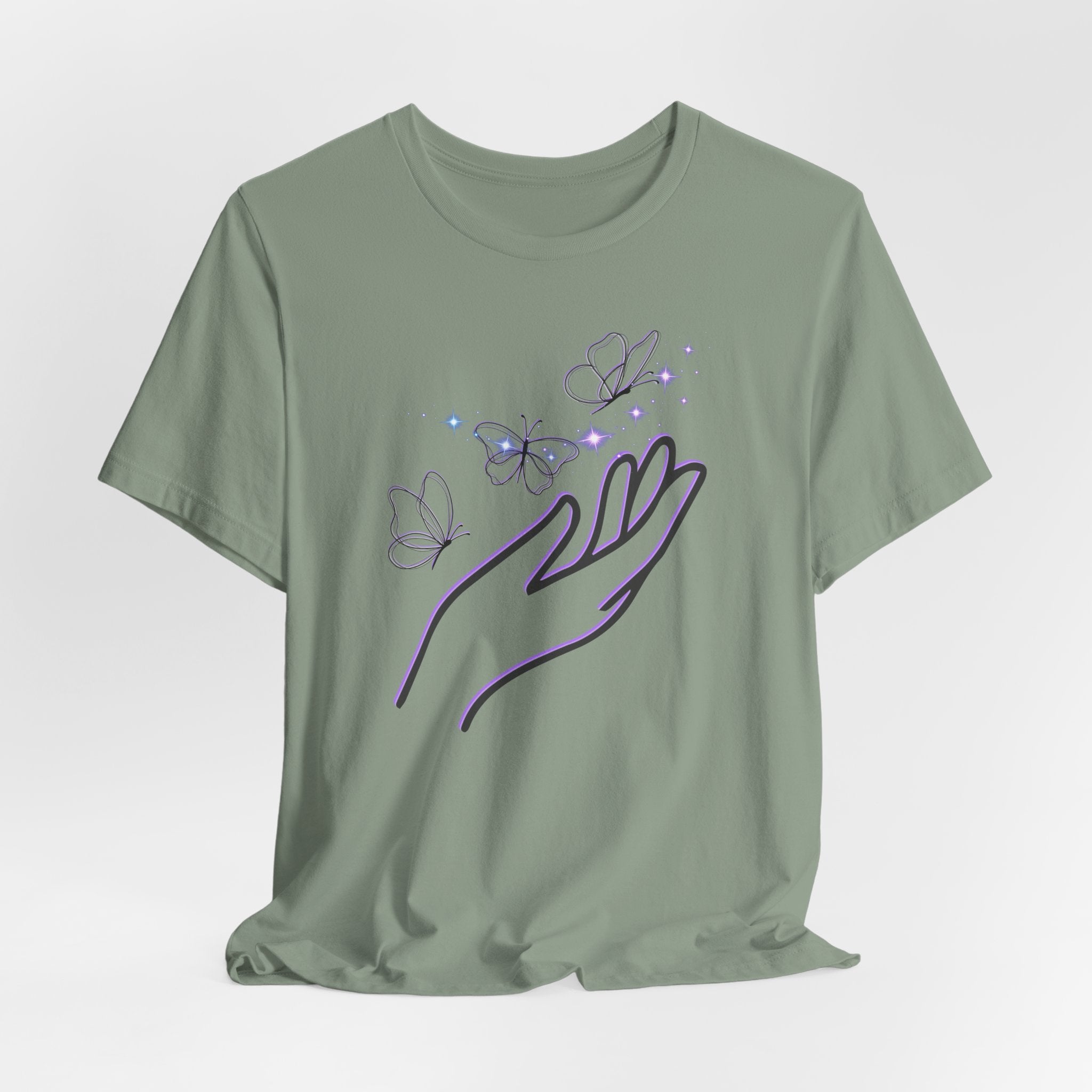 Green t-shirt with a design of a hand holding butterflies on a light gray background