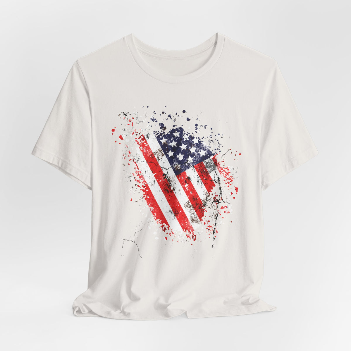 White t-shirt with American flag design on a light gray background