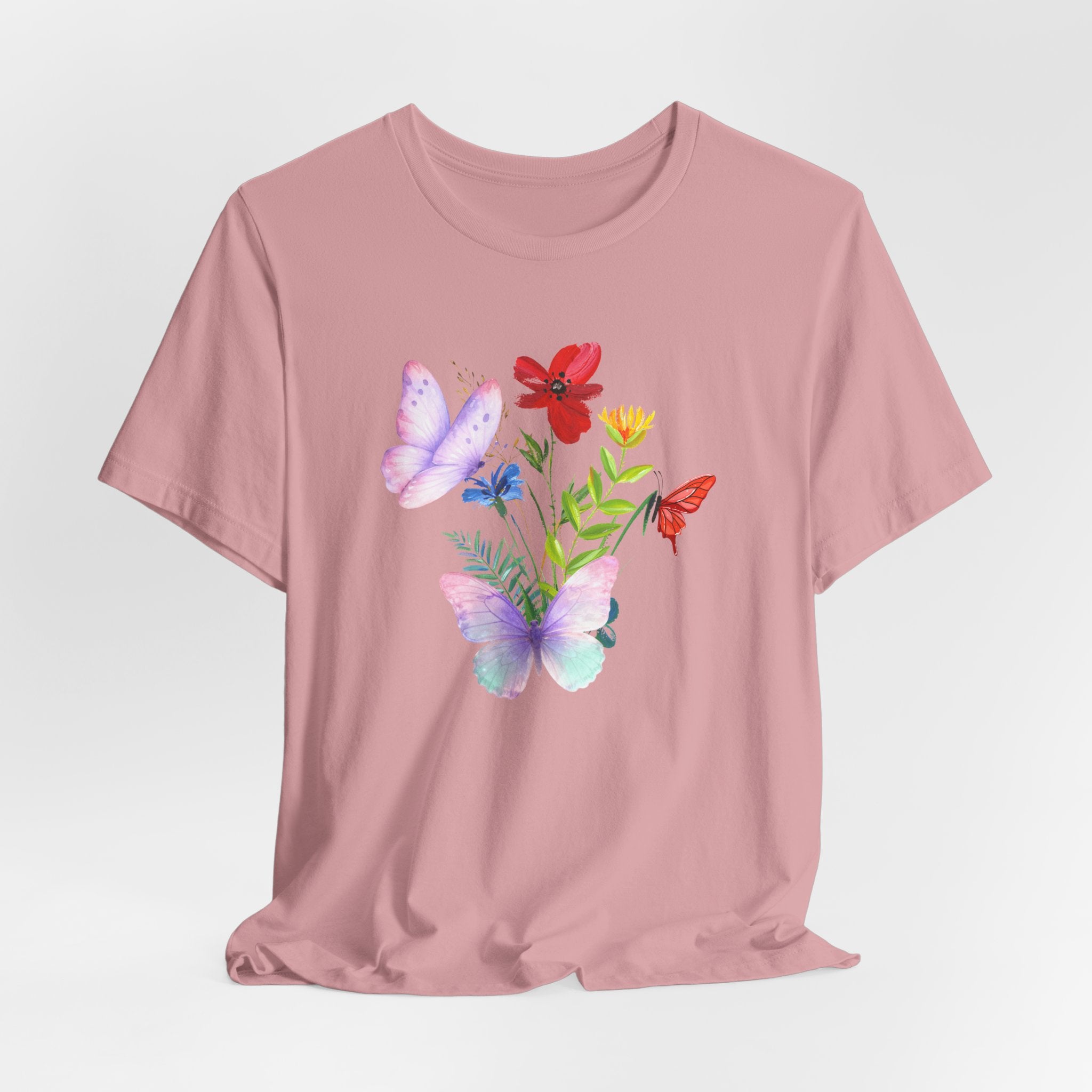 Pink t-shirt with colorful butterfly and flower design on a light gray background
