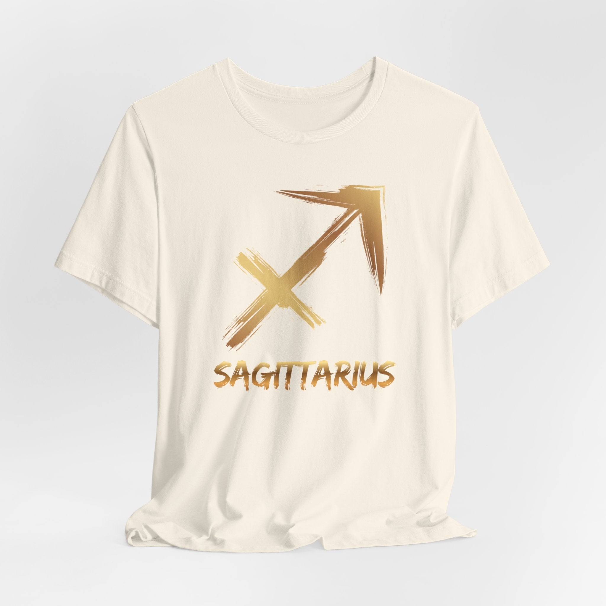 White t-shirt with gold Sagittarius symbol and text on a light gray background