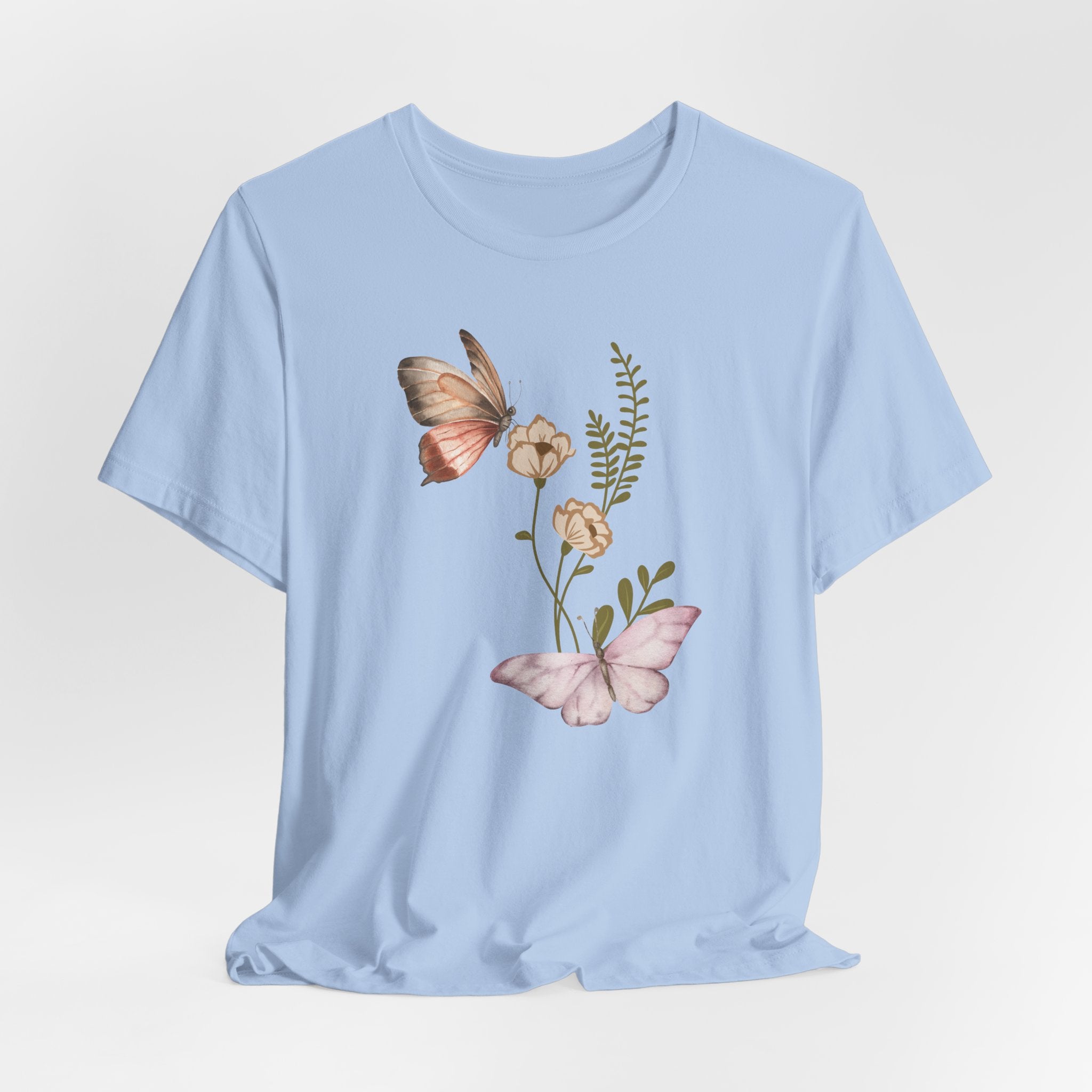 Light blue t-shirt with butterfly and floral design on a light gray background