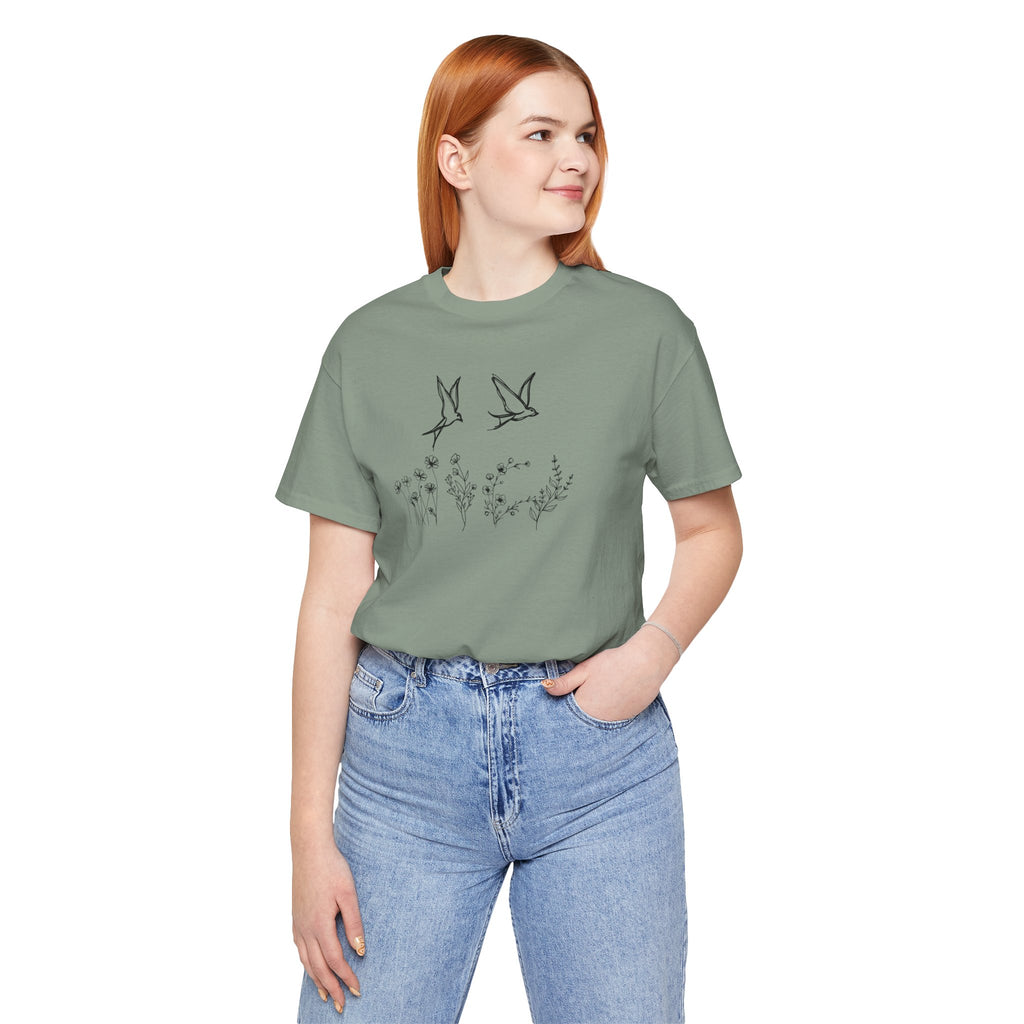 Person wearing a green t-shirt with a graphic design on a white background