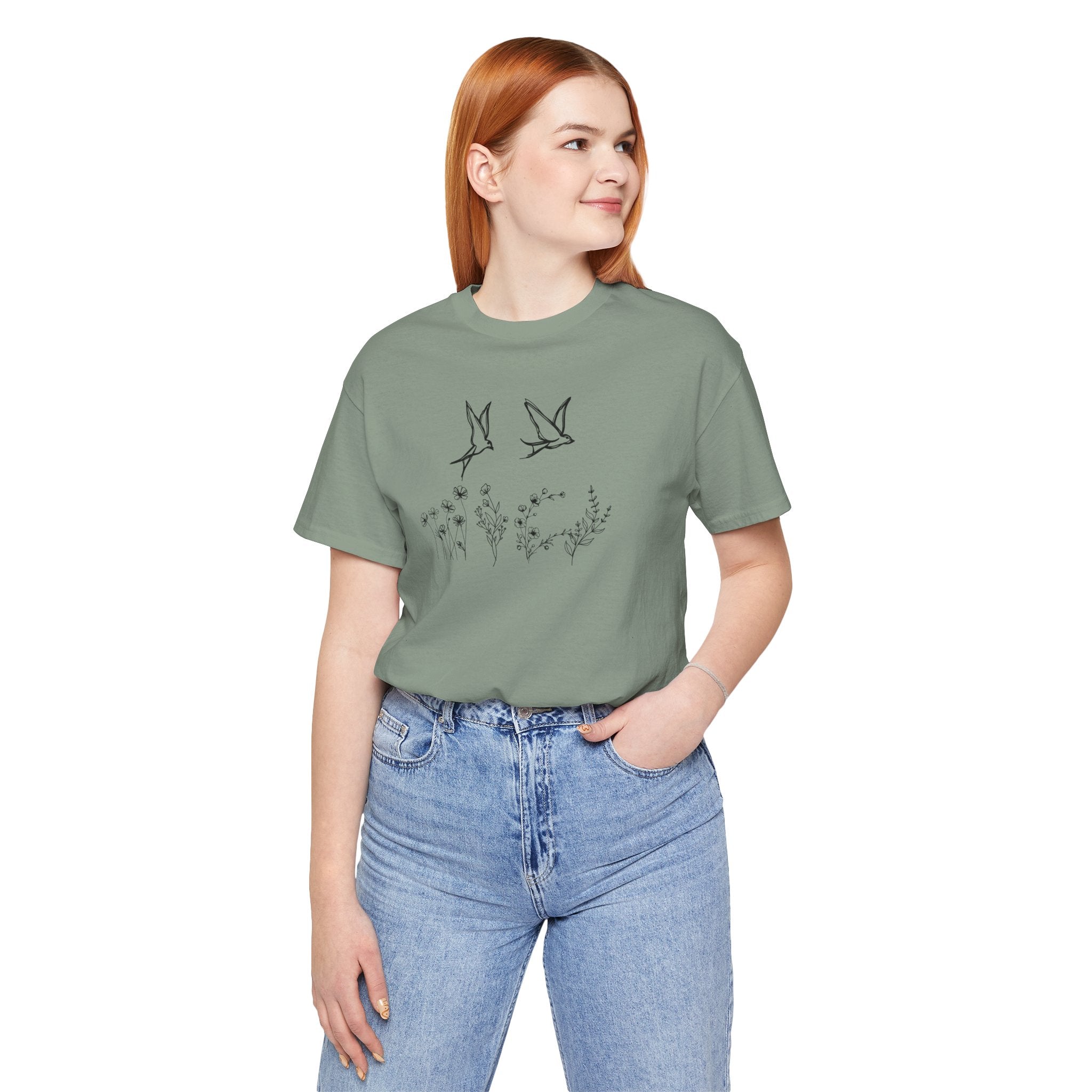 Person wearing a green t-shirt with a graphic design on a white background