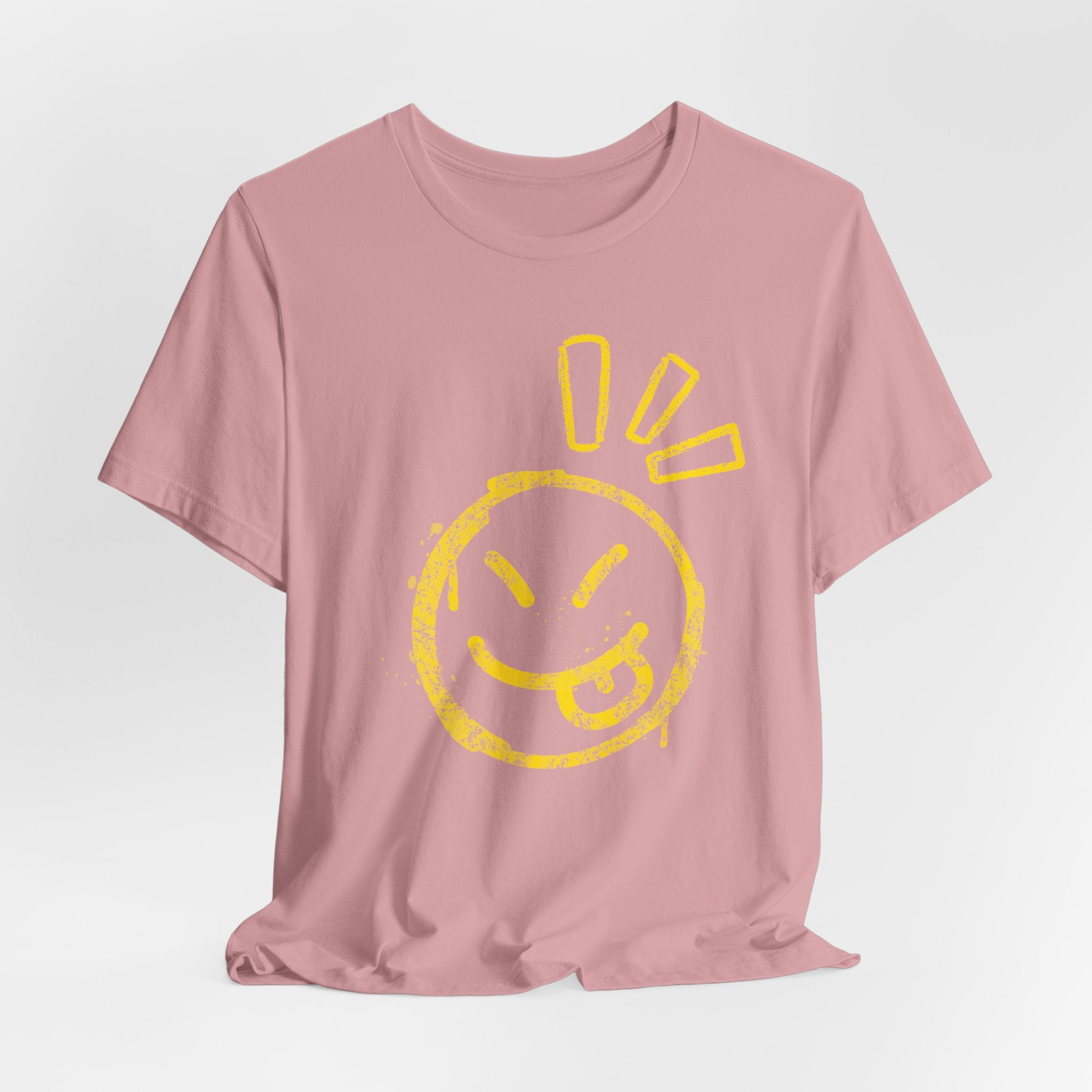 Pink t-shirt with a yellow smiley face design on a light gray background