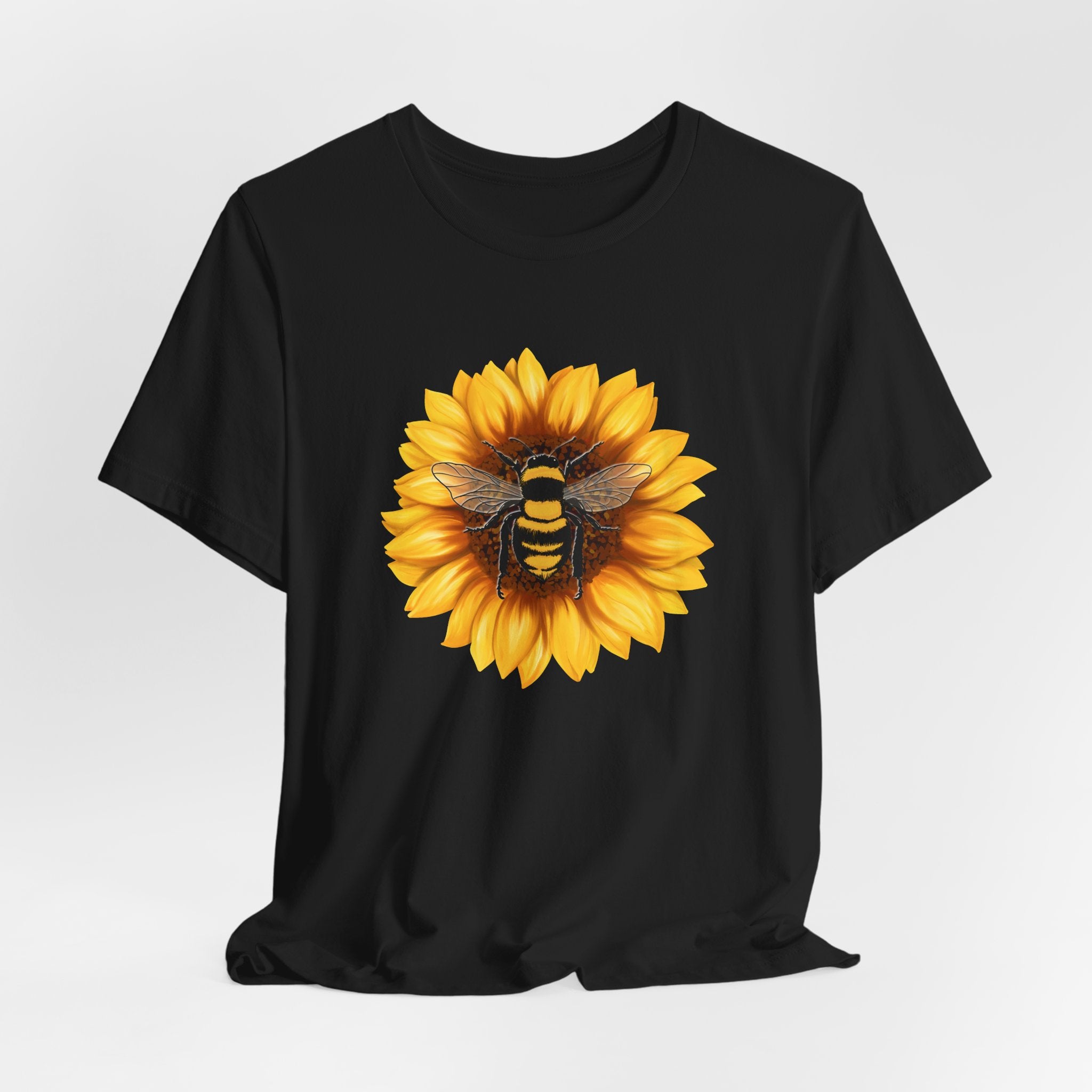Black t-shirt with a sunflower and bee design on a white background