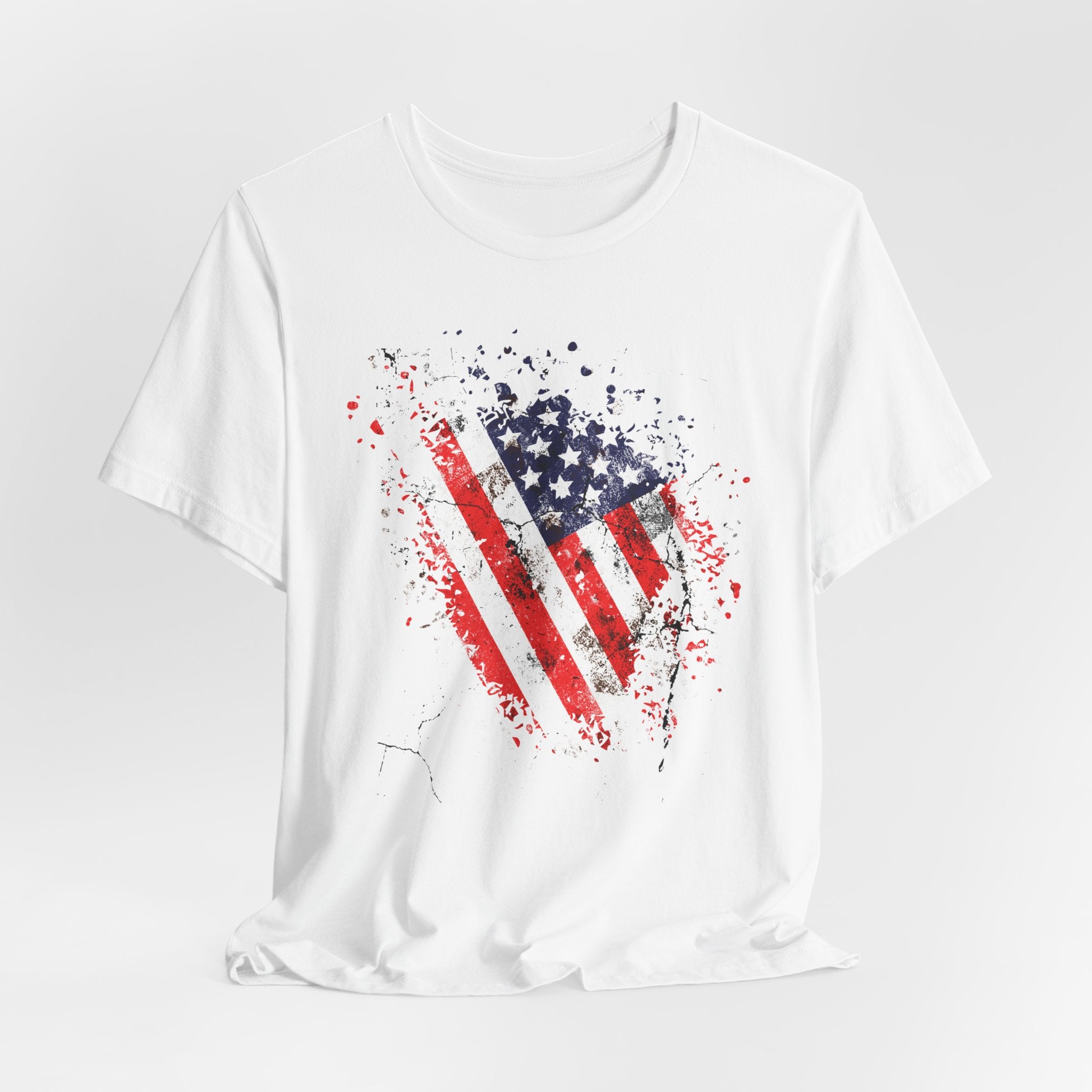 White t-shirt with American flag graphic on a light gray background