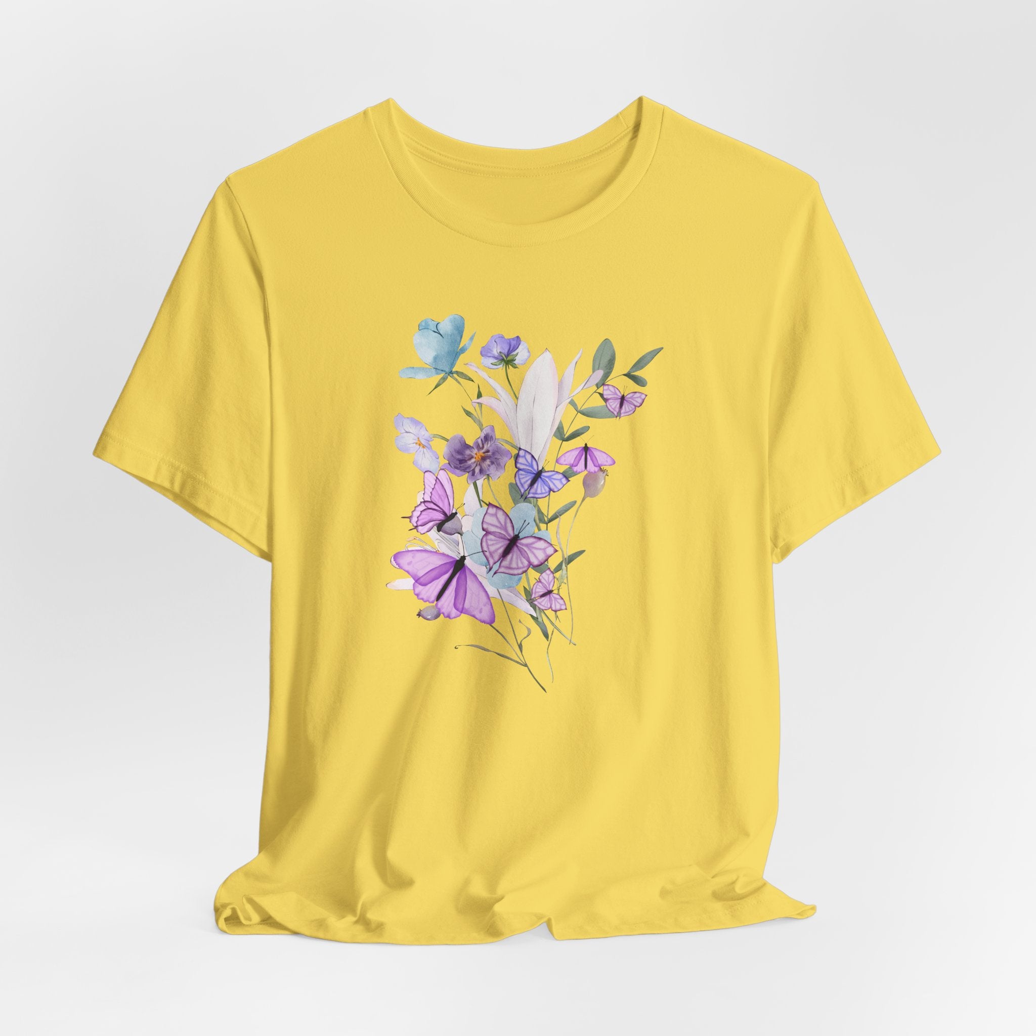 Yellow t-shirt with floral design on a light gray background