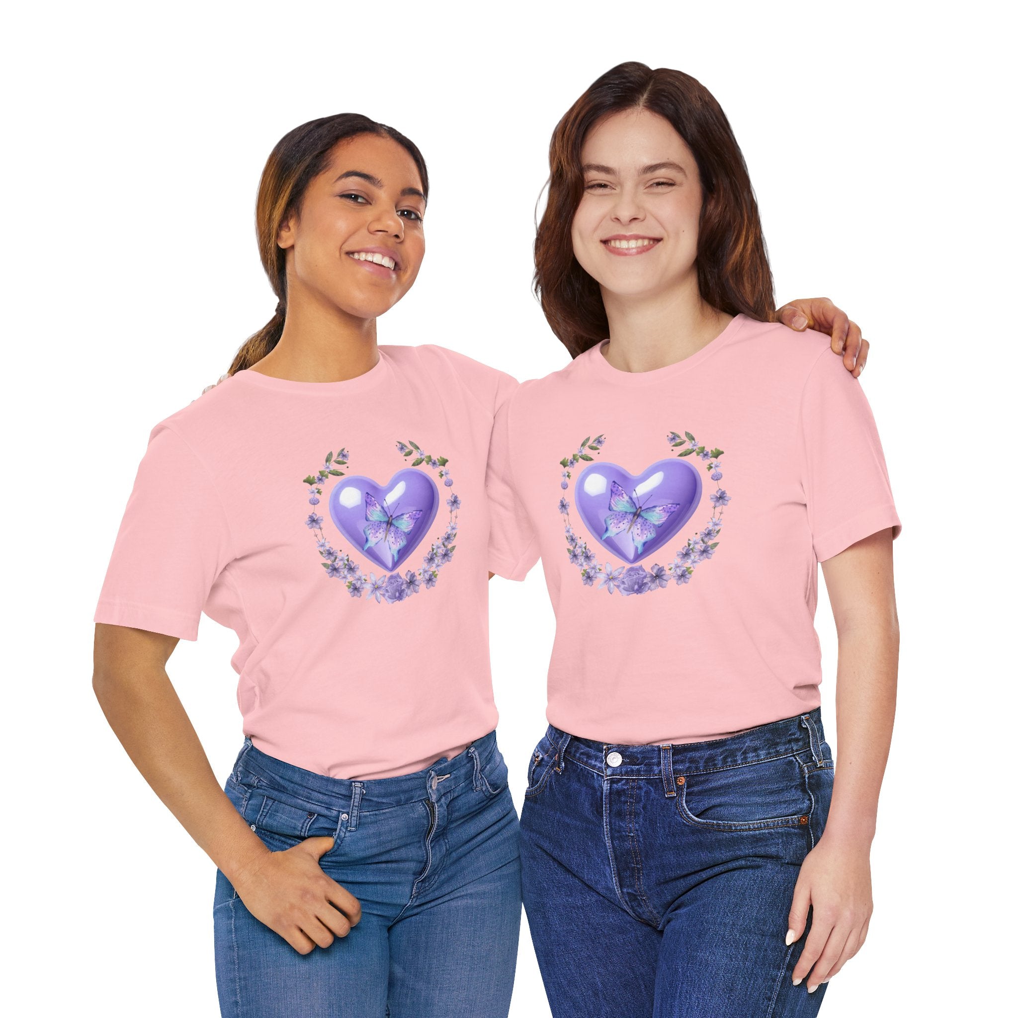 Two women wearing pink t-shirts with a heart and flower design on a white background