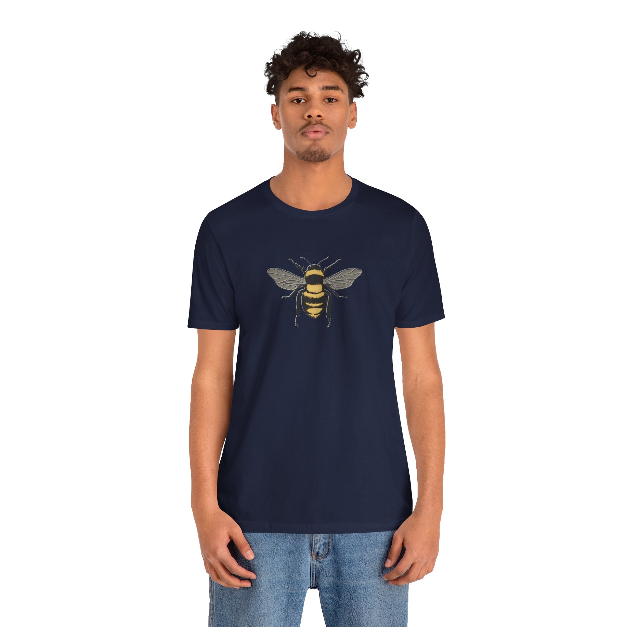 Person wearing a navy blue t-shirt with a bee design on a white background