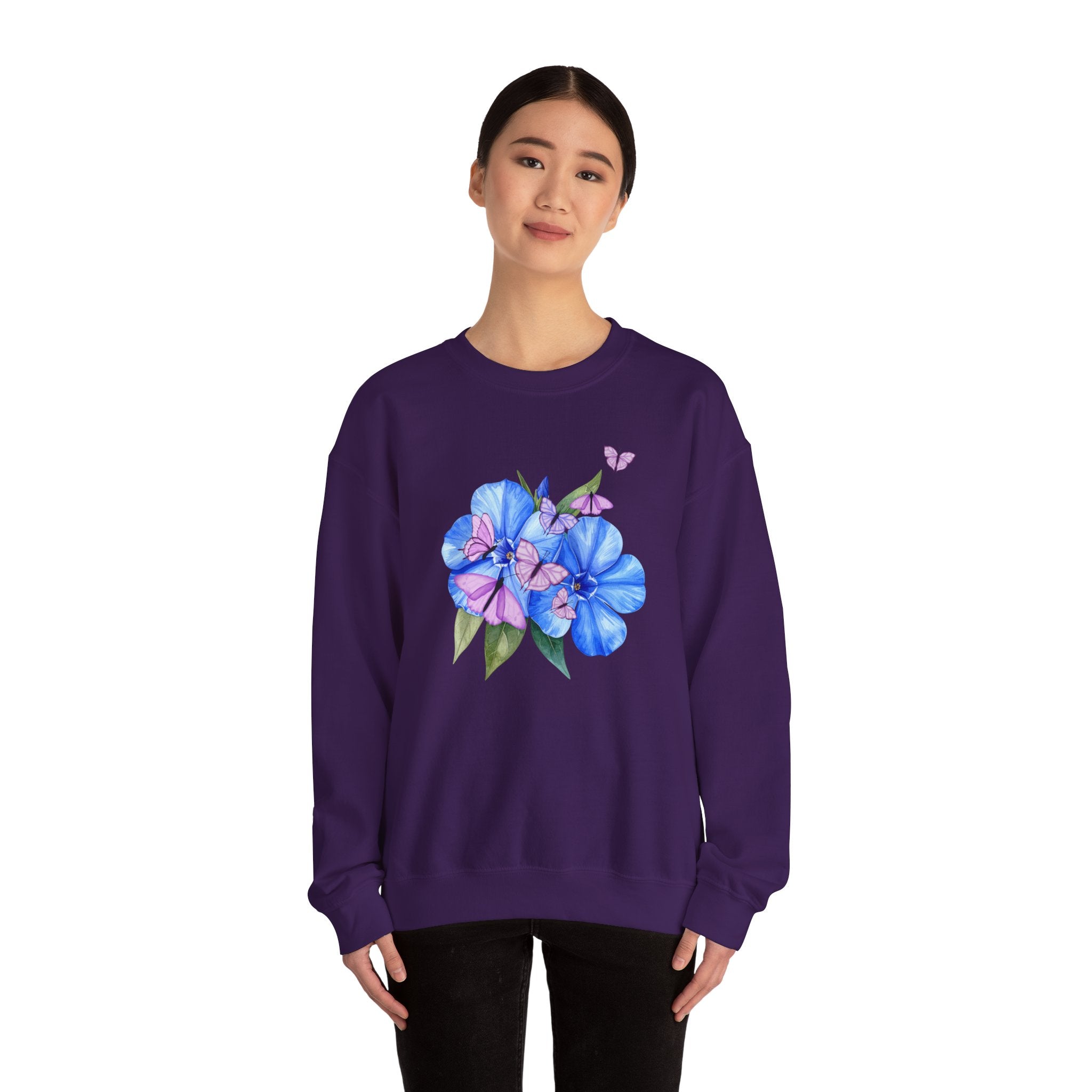 Person wearing a purple sweatshirt with a floral design on a white background