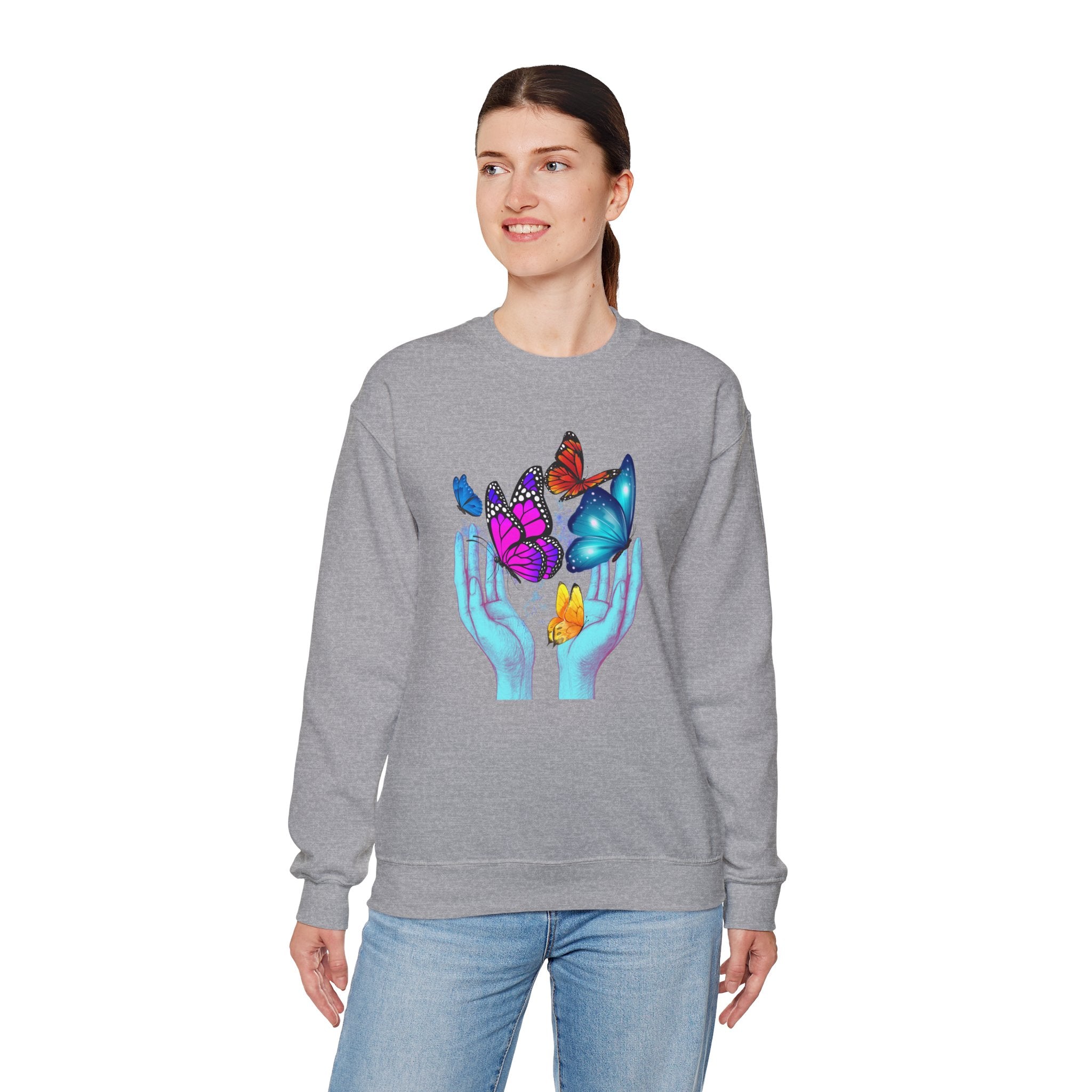 Person wearing a gray sweatshirt with colorful butterfly design on a white background