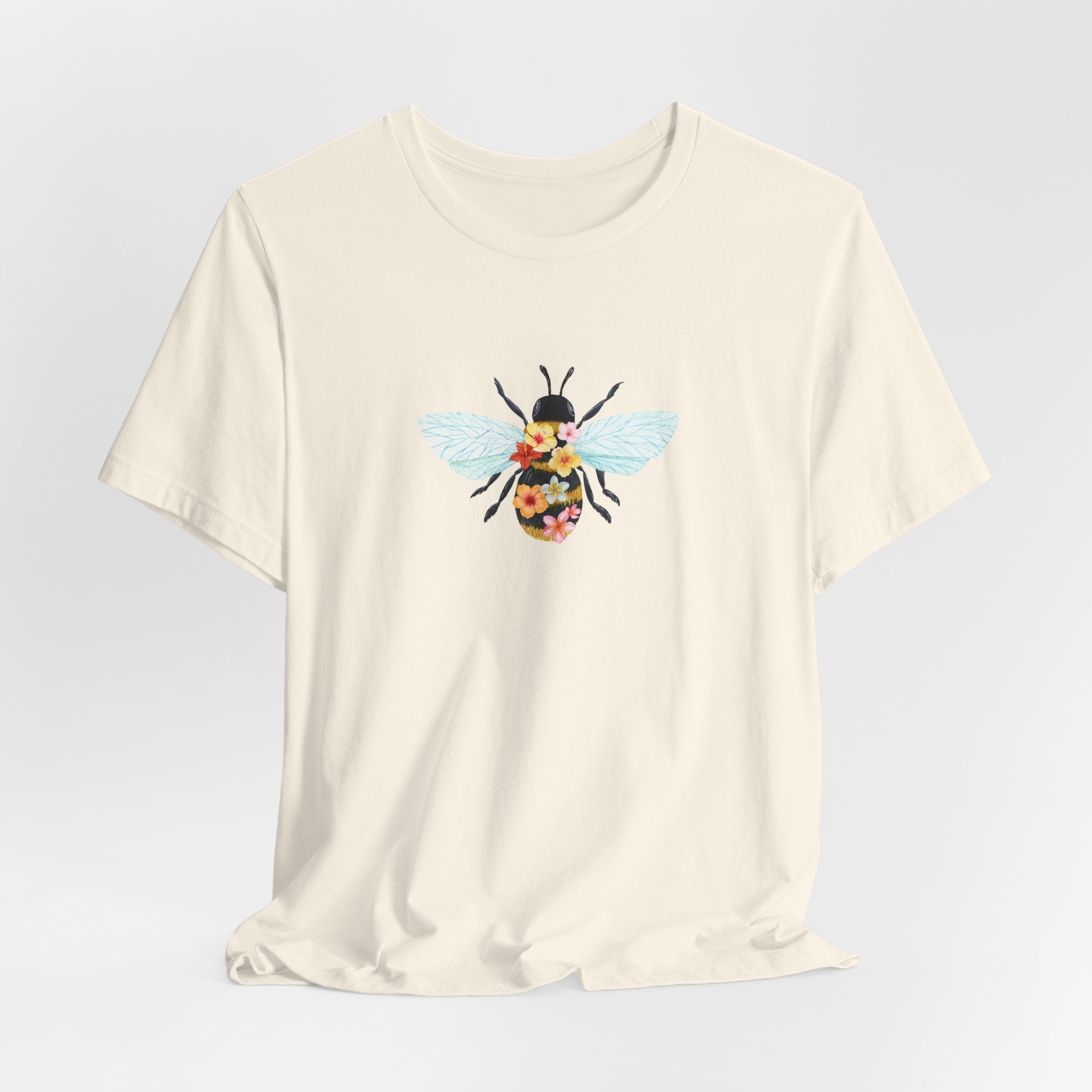 Beige t-shirt with a bee graphic on a light gray background