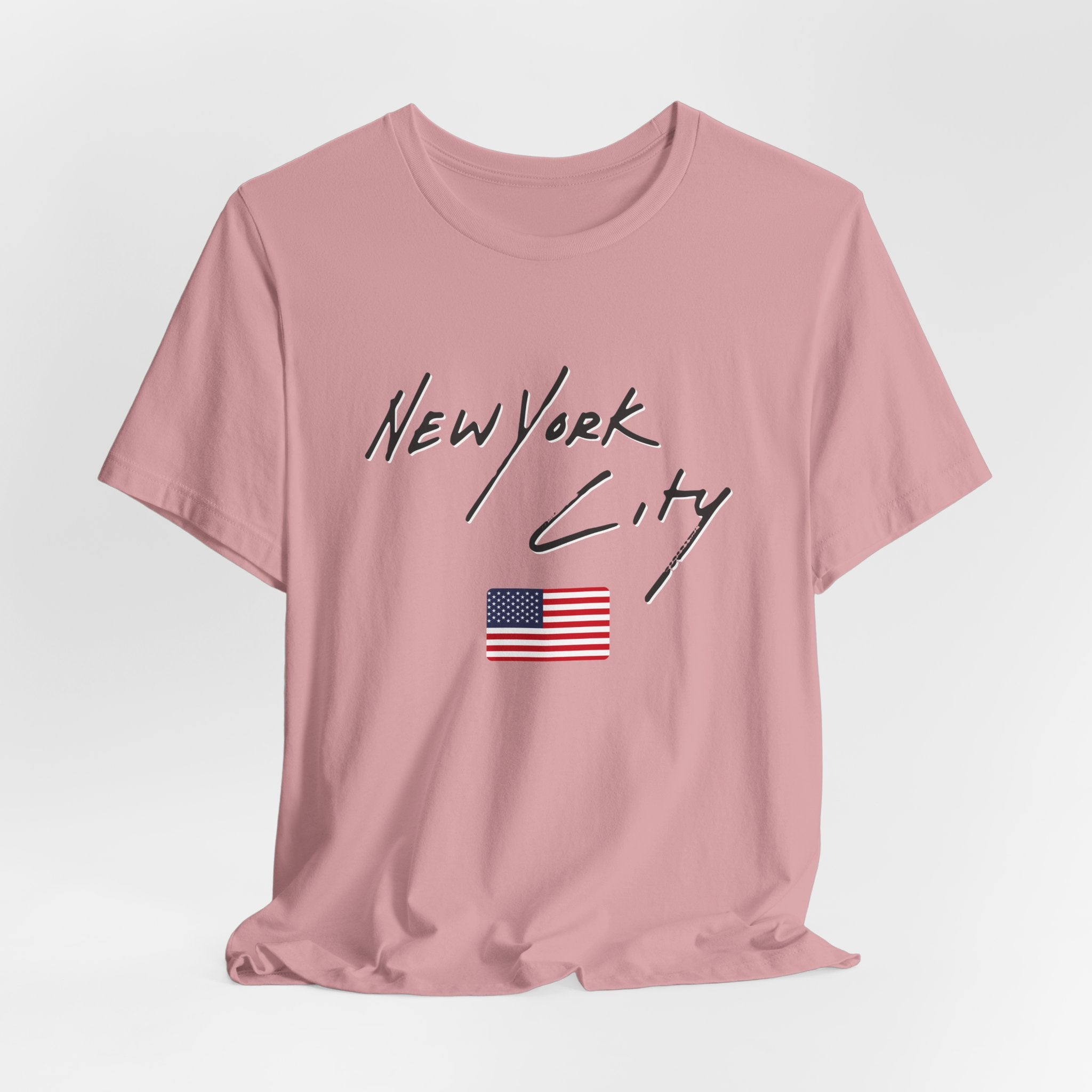 Pink t-shirt with 'New York City' text and American flag on a light gray background