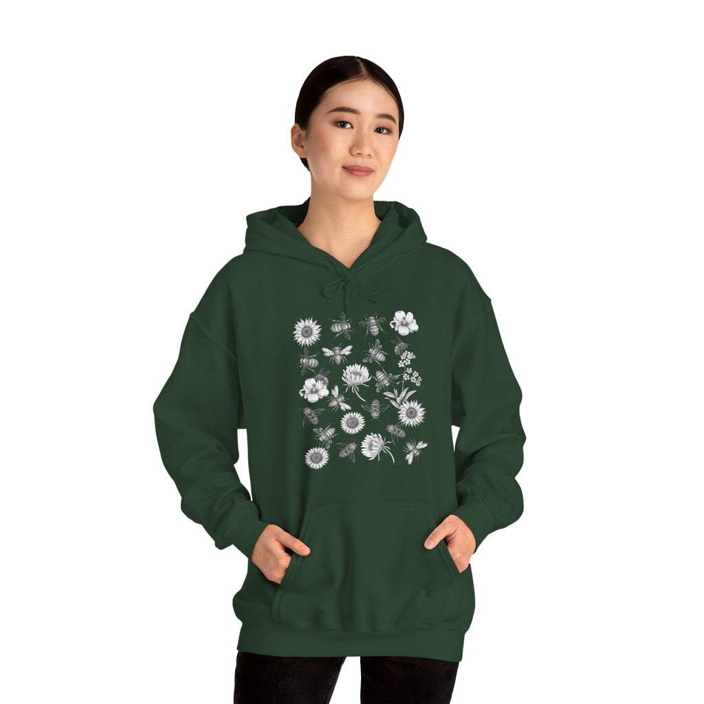 Person wearing a green hoodie with floral and bee design on a white background