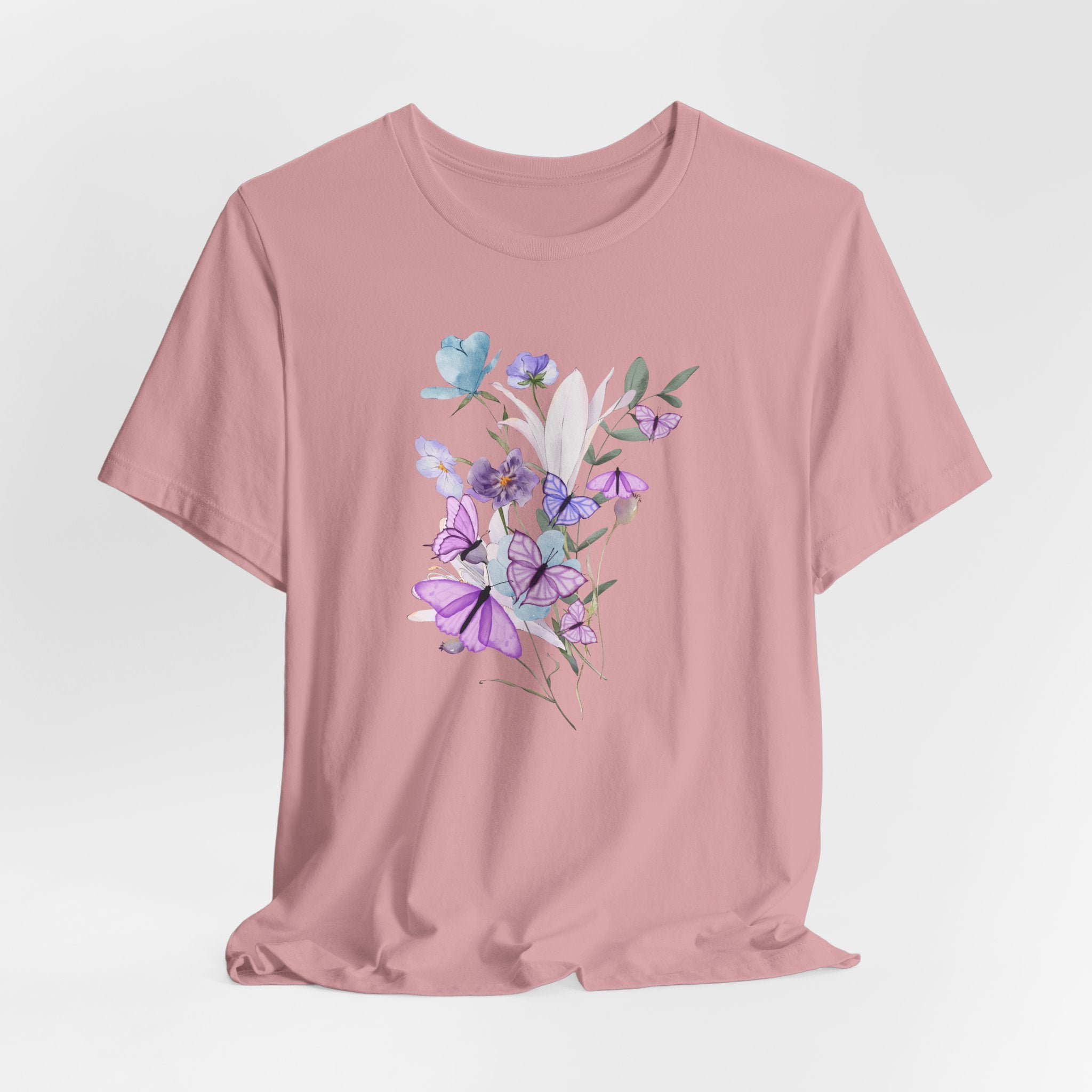 Pink t-shirt with floral design on a light gray background
