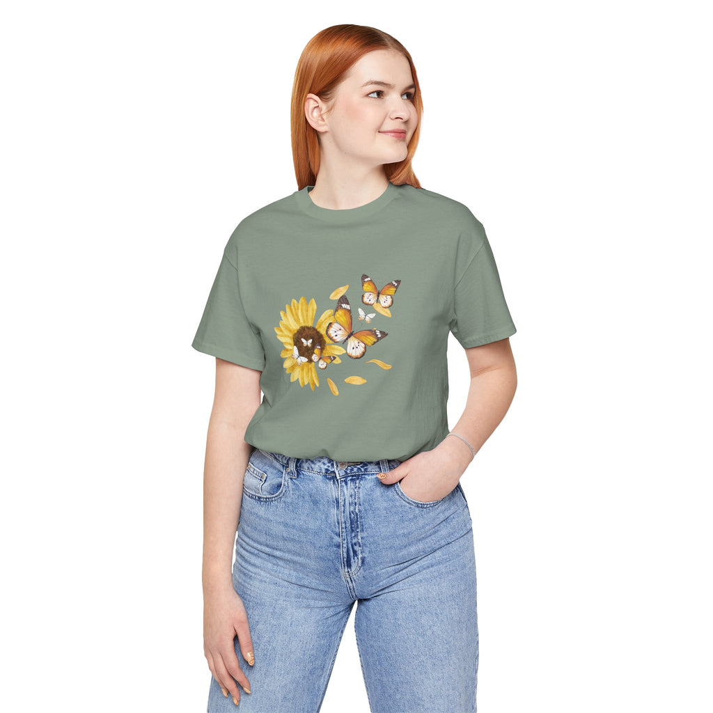 Person wearing a green t-shirt with a sunflower design on a white background