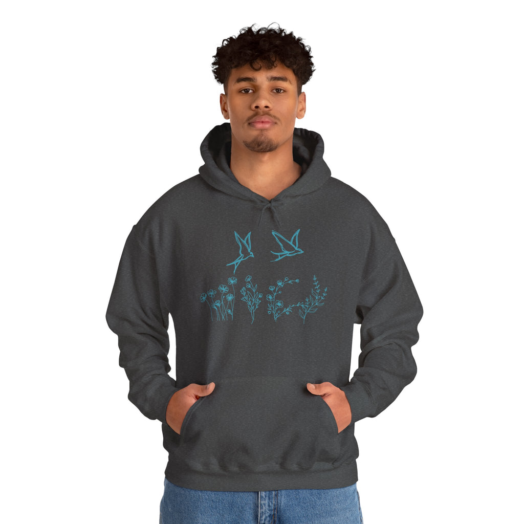 Person wearing a dark gray hoodie with a bird and flower graphics on a white background