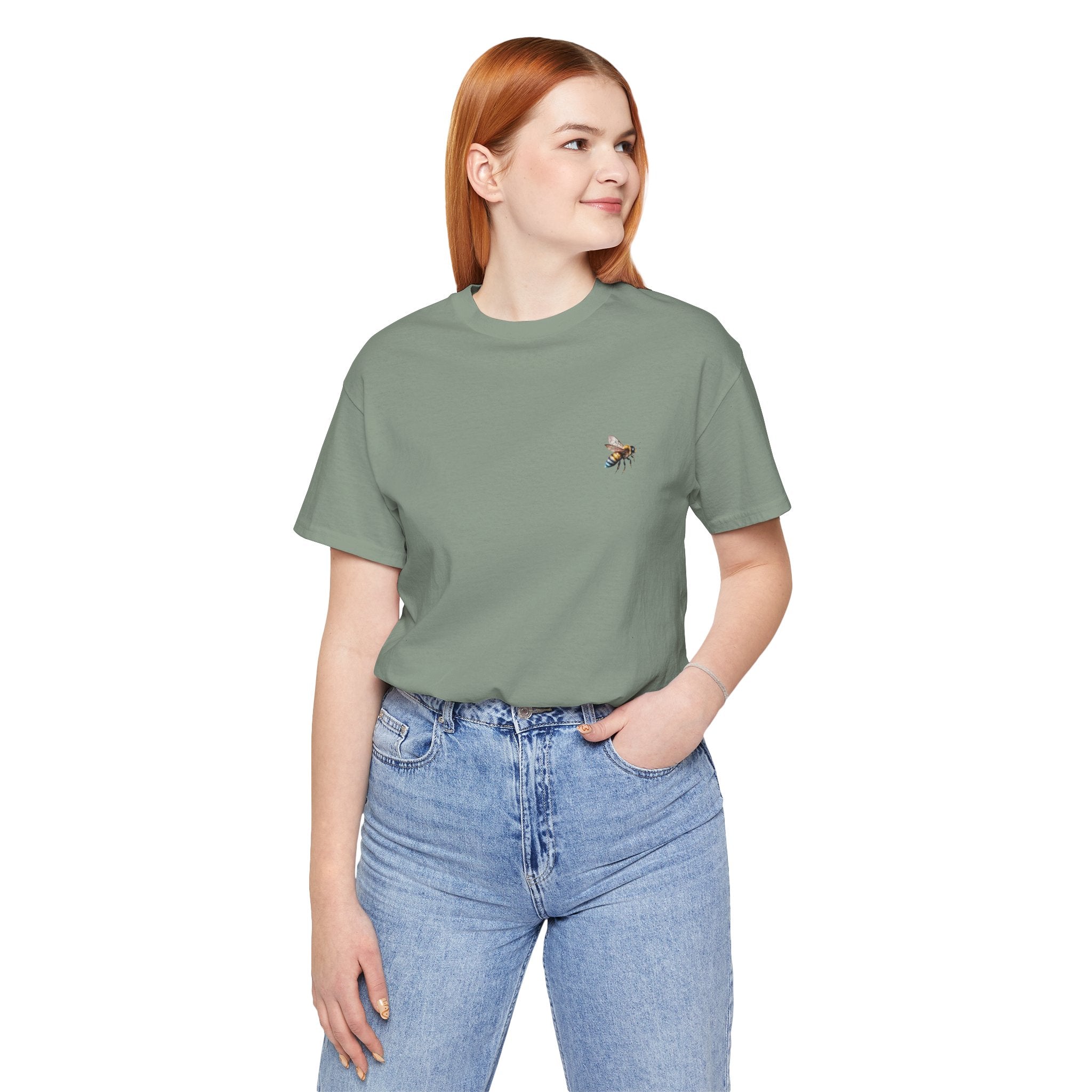 Person wearing a green t-shirt with a graphic design and blue jeans on a white background