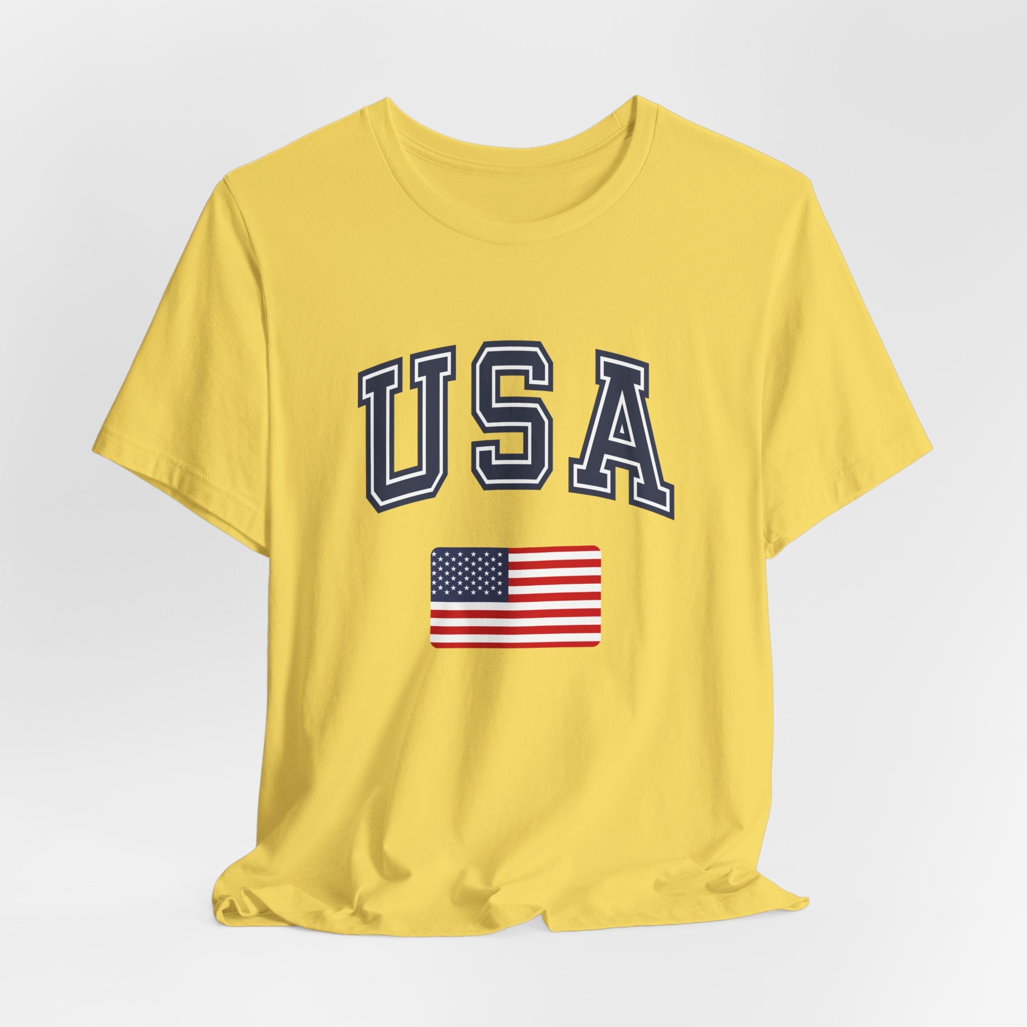 Yellow t-shirt with 'USA' and American flag on a light gray background
