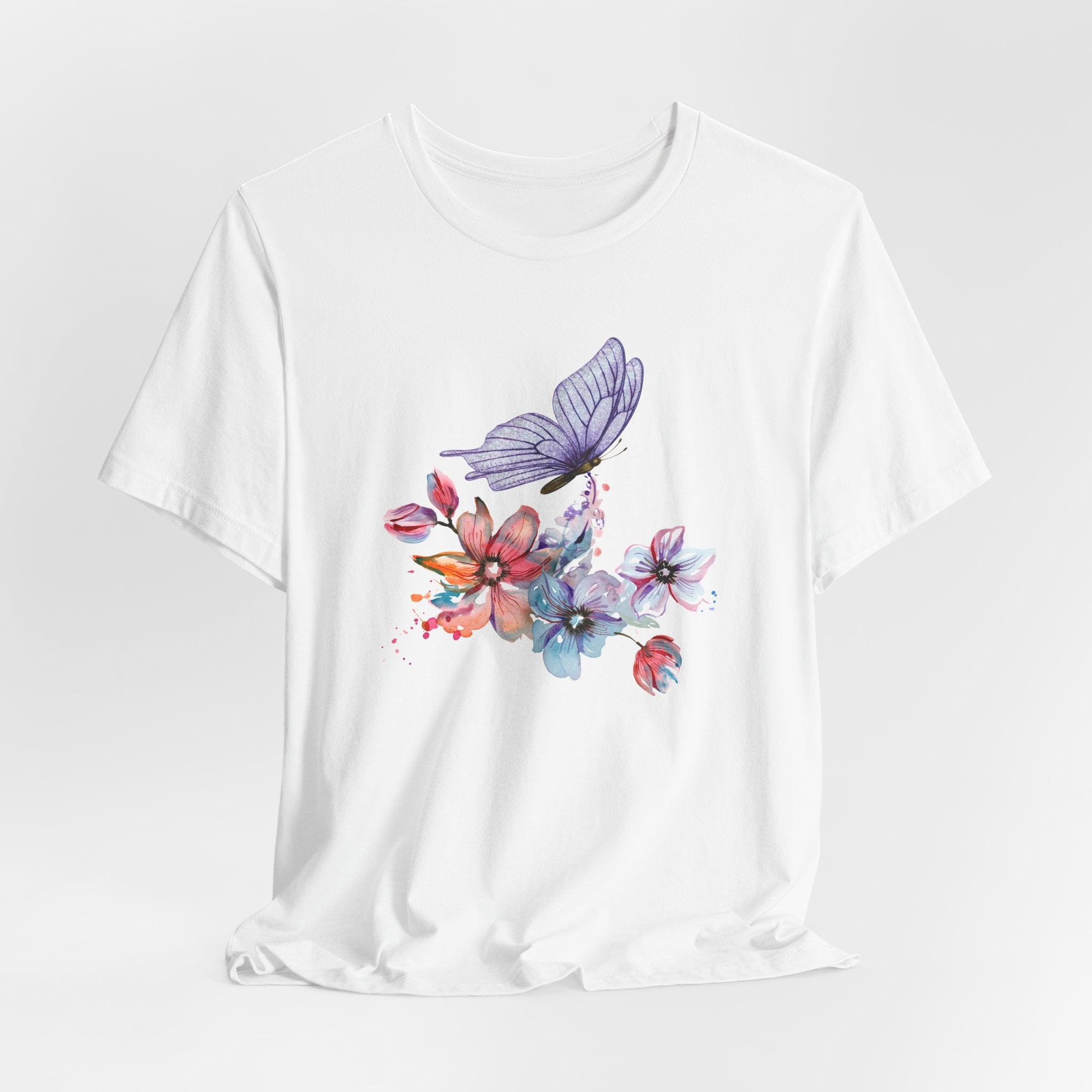 White t-shirt with colorful butterfly and floral design on a white background