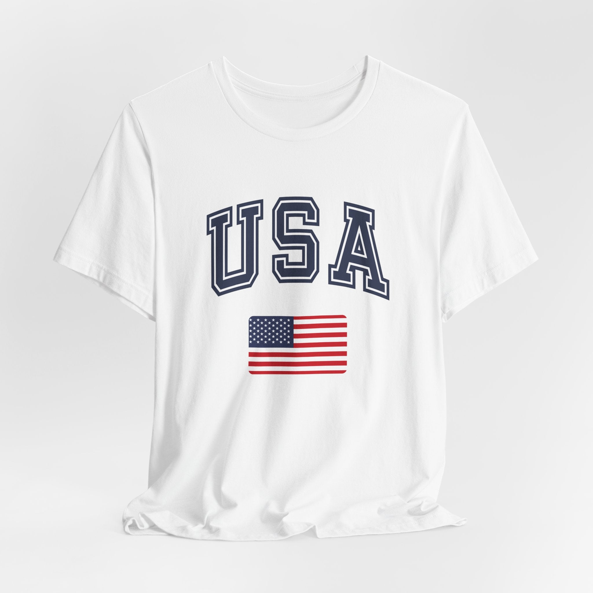 White t-shirt with 'USA' text and American flag on a light gray background