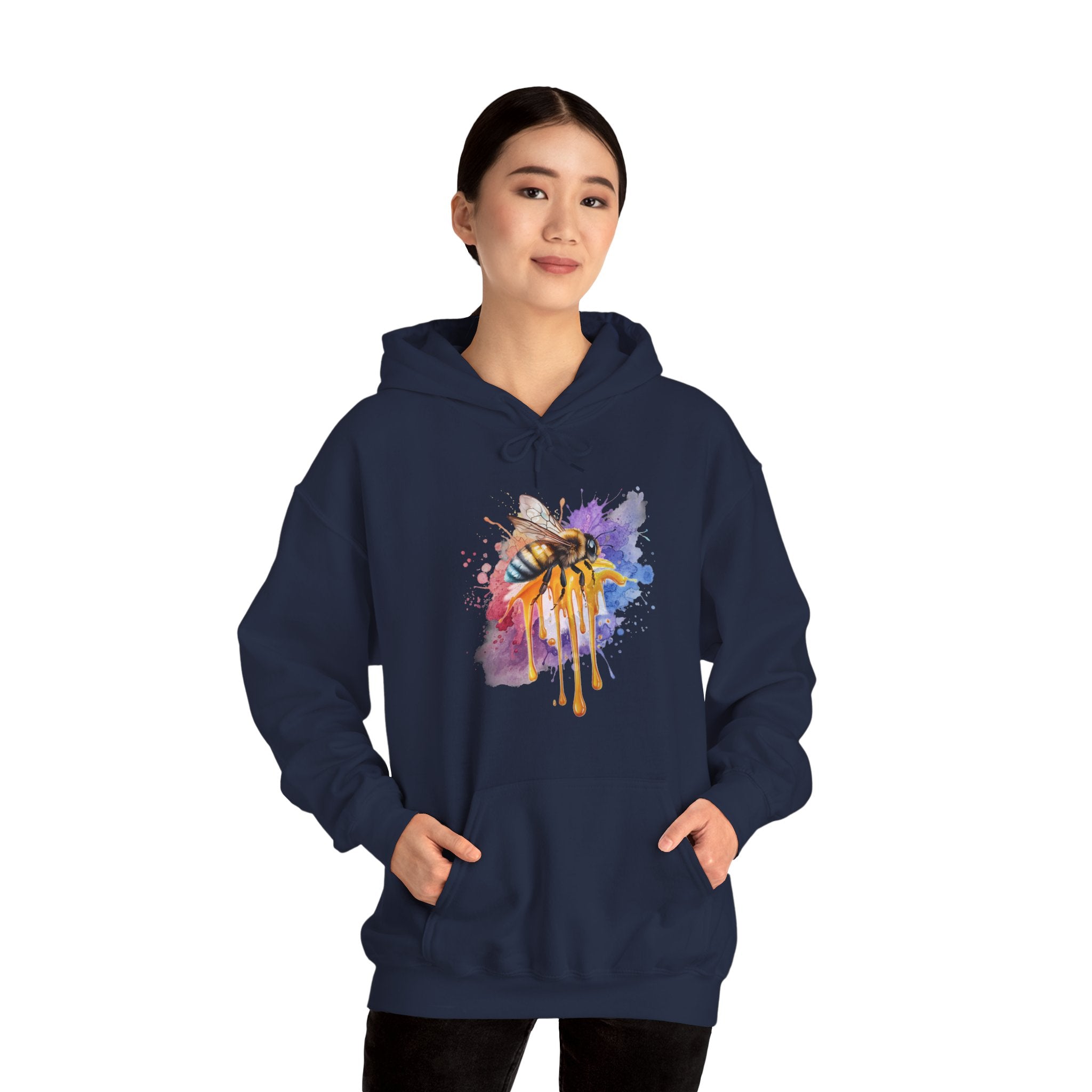 Person wearing a navy blue hoodie with a colorful bee design on a white background