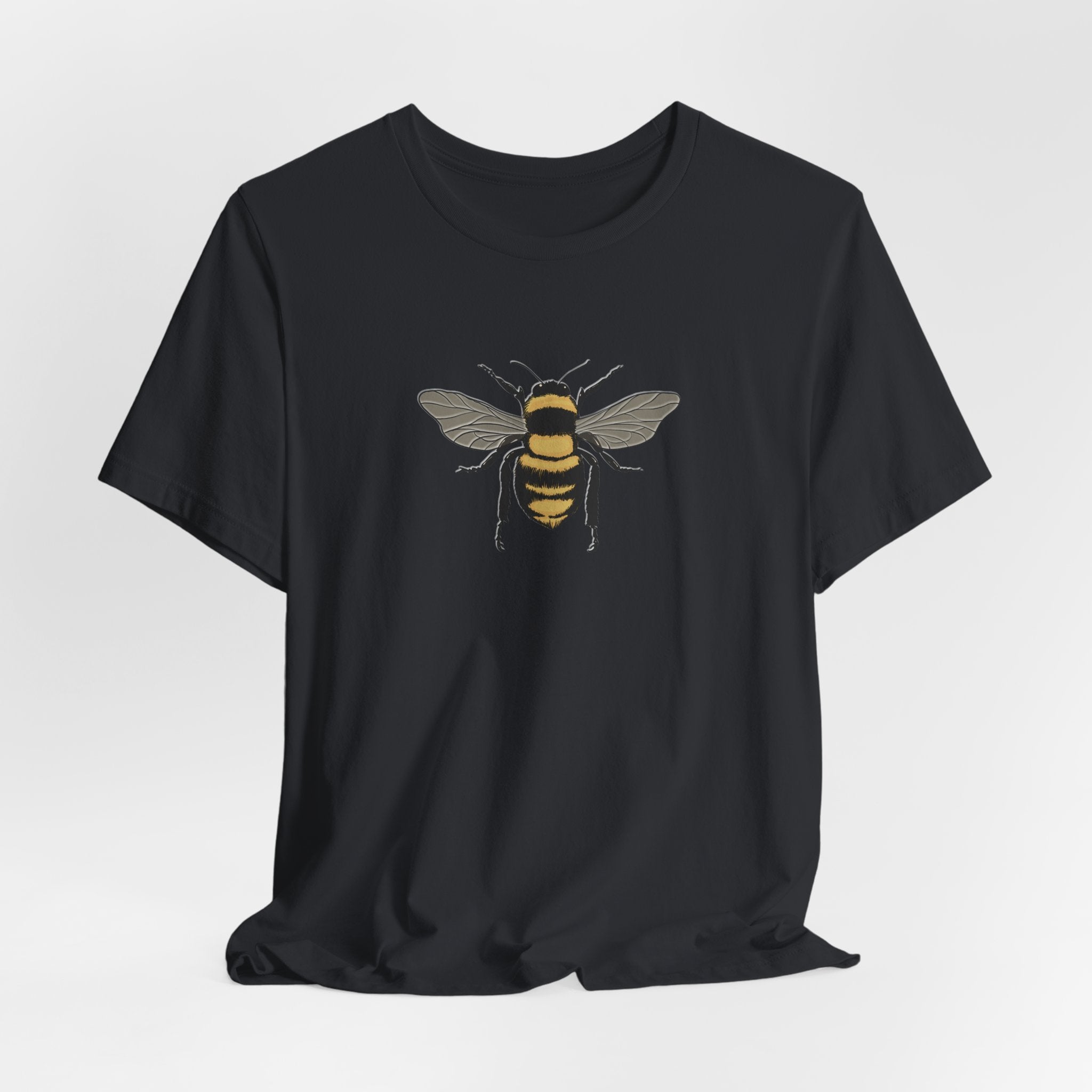 Black t-shirt with a bee design on a light gray background