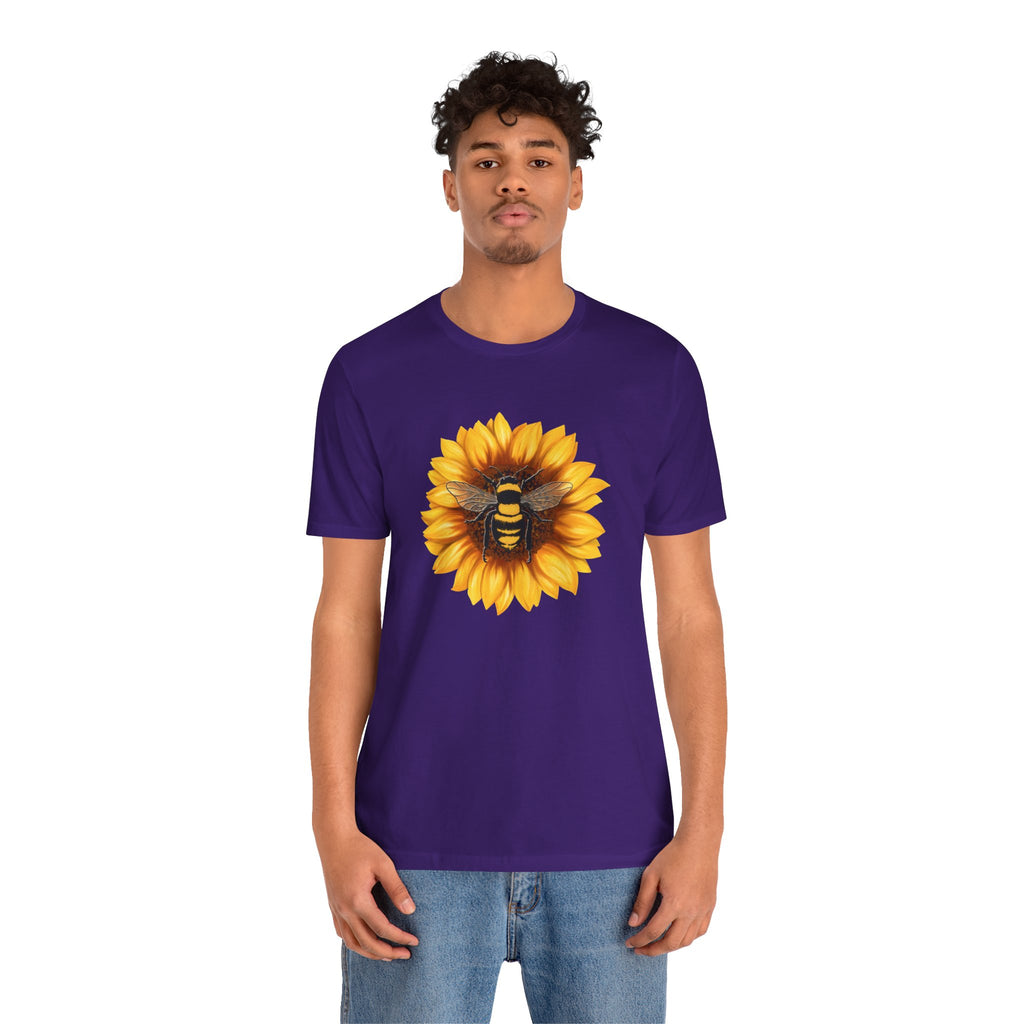 Person wearing a purple t-shirt with a sunflower and bee design on a white background