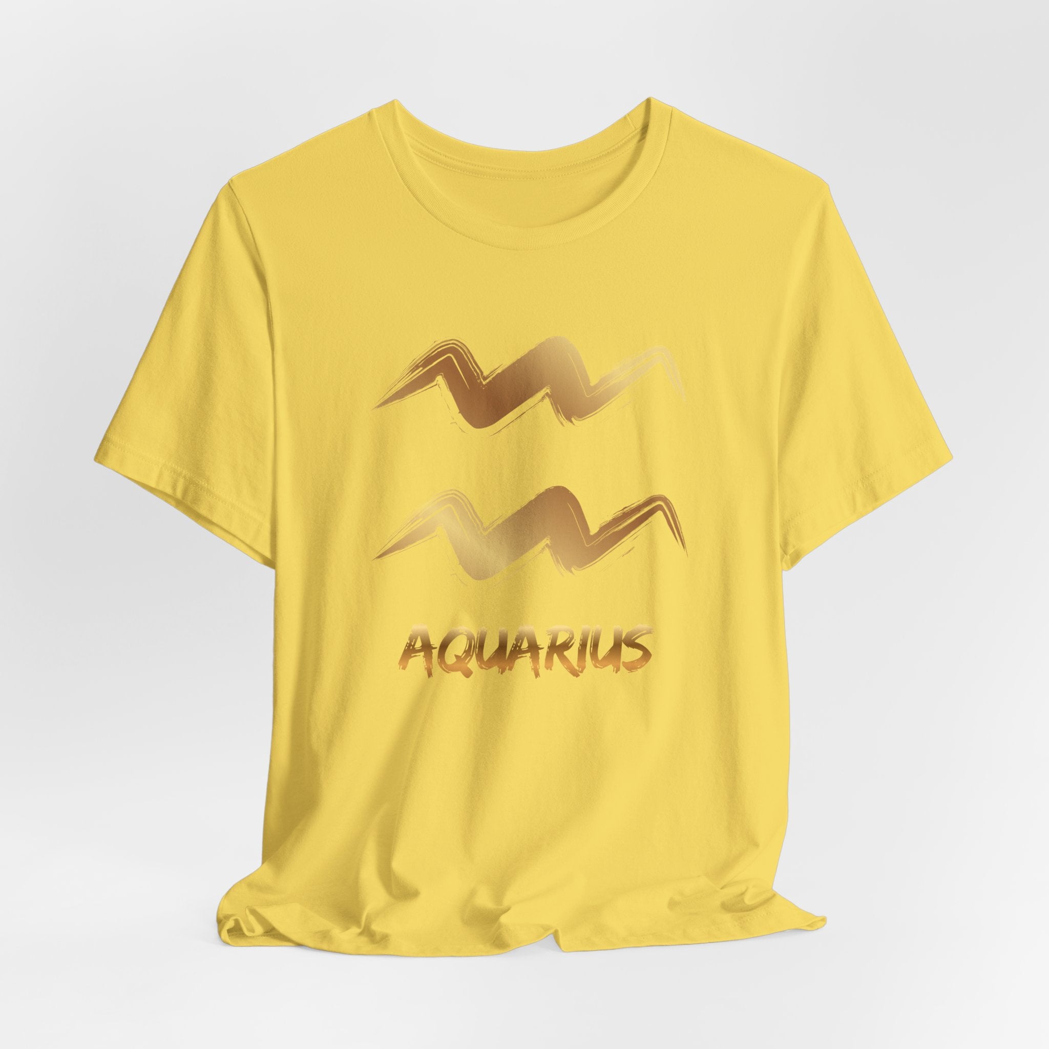 Yellow t-shirt with gold Aquarius zodiac sign design on a light gray background